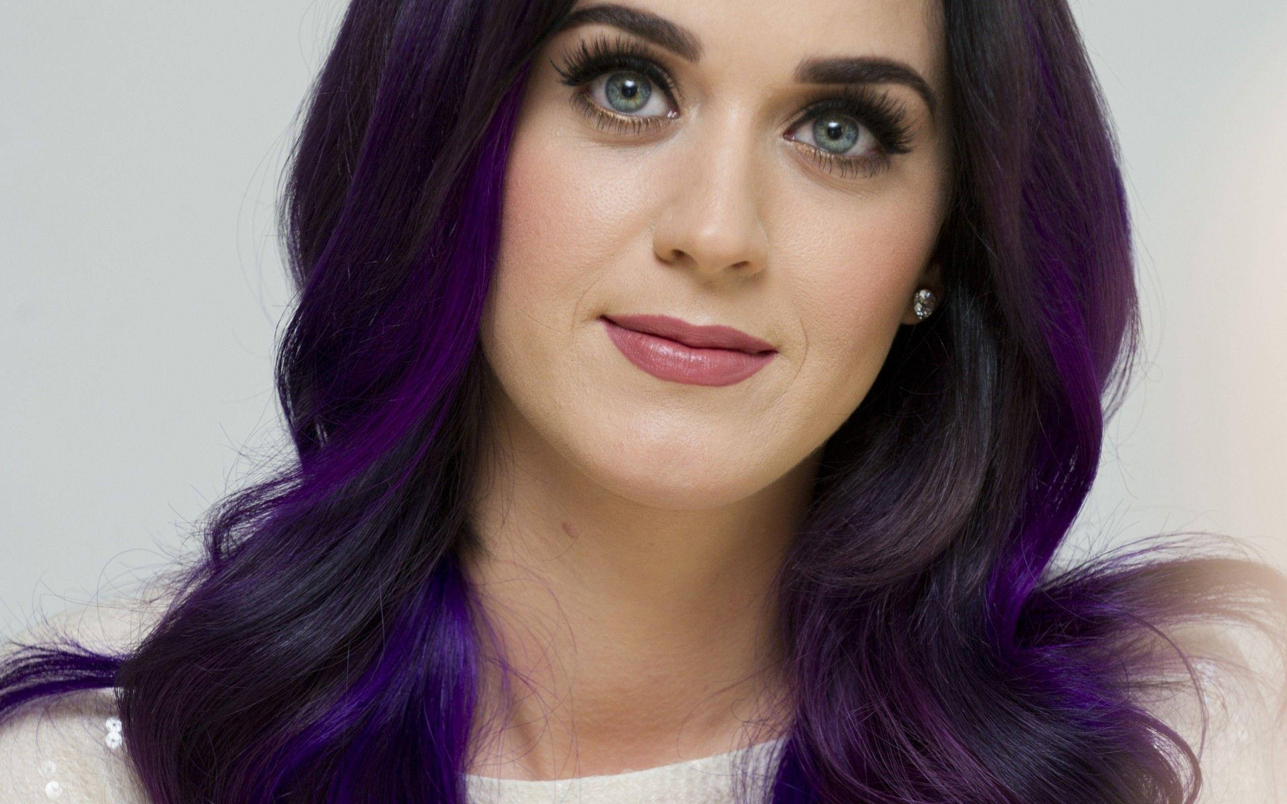Katy Perry, vibrant purple hair, striking blue eyes, 2K Desktop Wallpaper