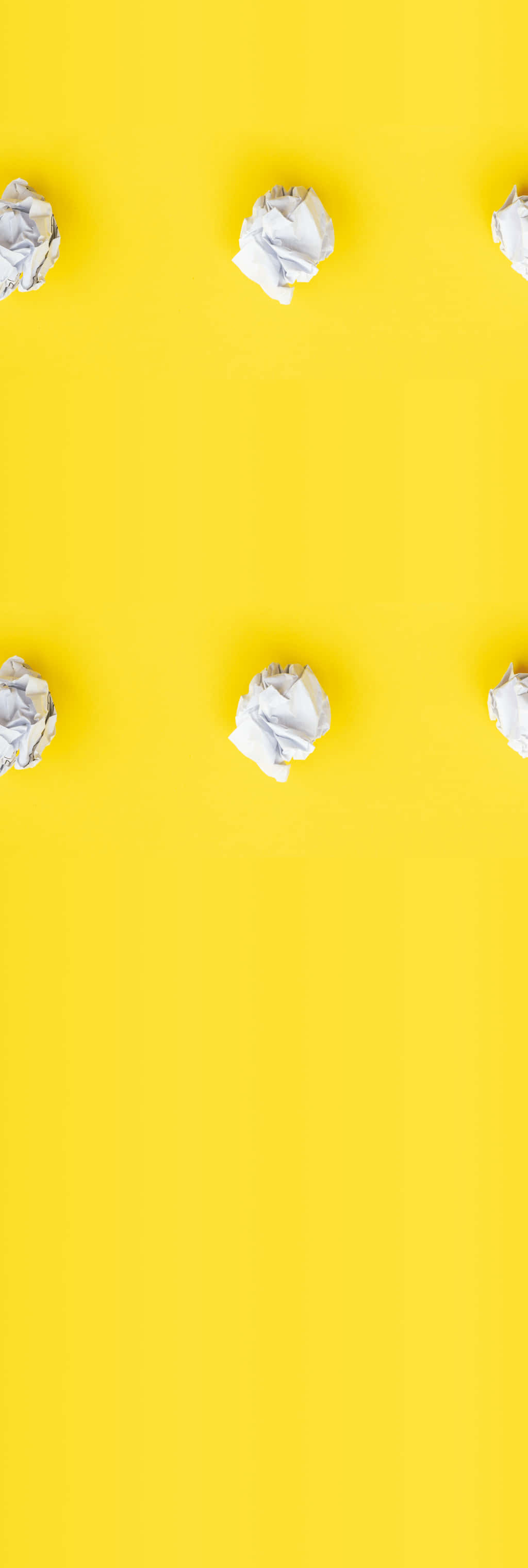 Kawaii Yellow, vibrant yellow background, six crumpled white paper balls, 2K Phone Wallpaper