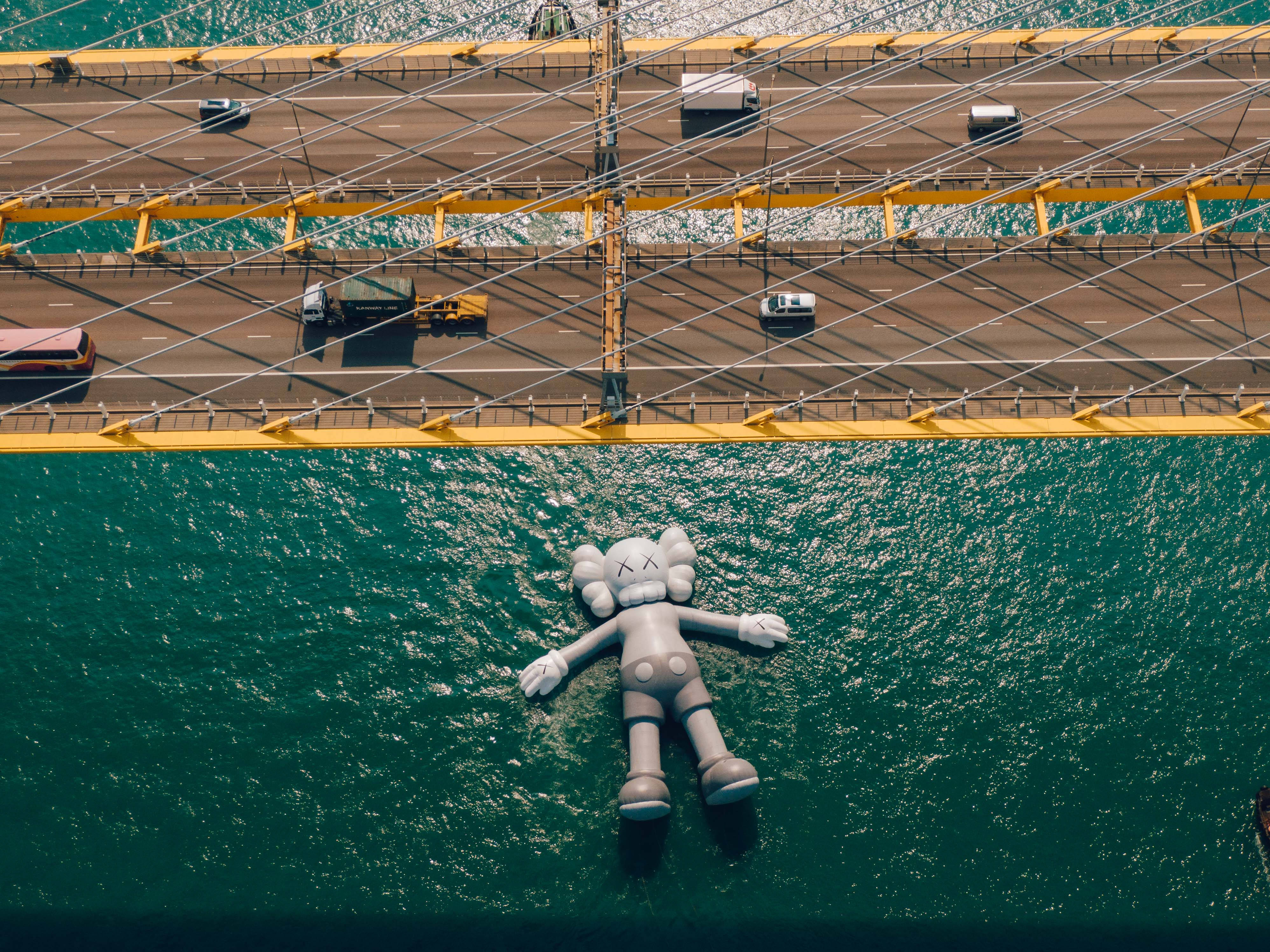 KAWS, suspension bridge, teal water, 4K Desktop Wallpaper