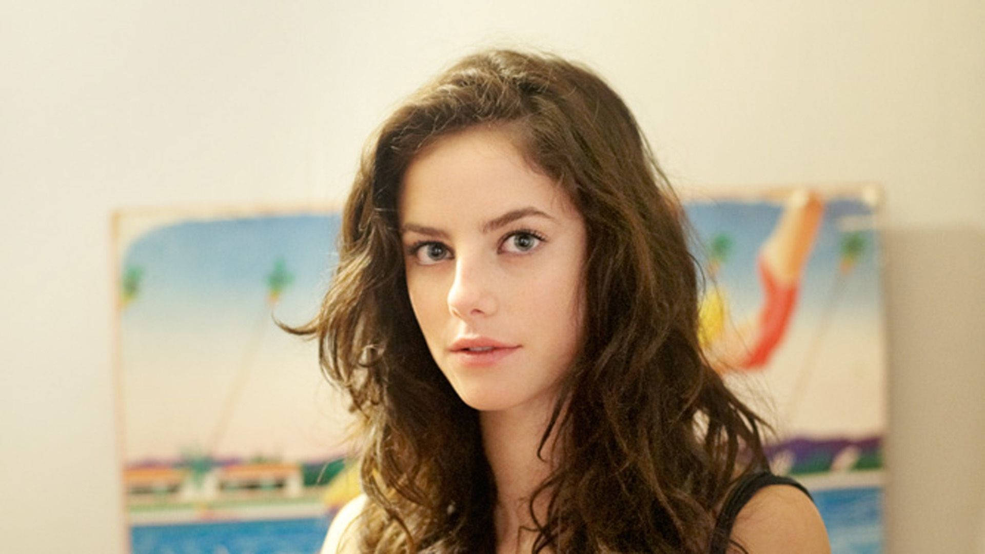 Kaya Scodelario, wavy brown hair, blurred tropical painting backdrop, Full HD Desktop Wallpaper