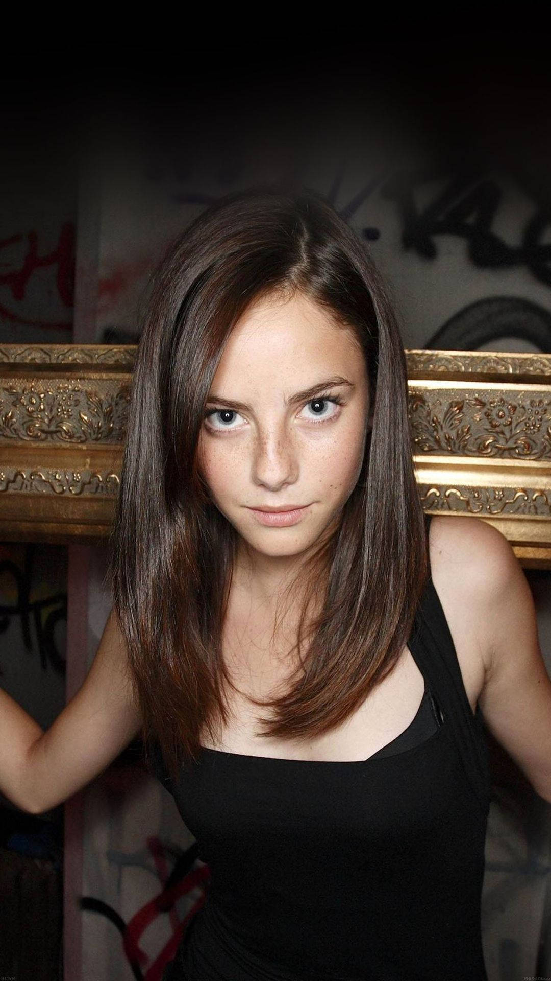 Kaya Scodelario, graffiti-covered wall, ornate golden frame, Full HD Phone Wallpaper