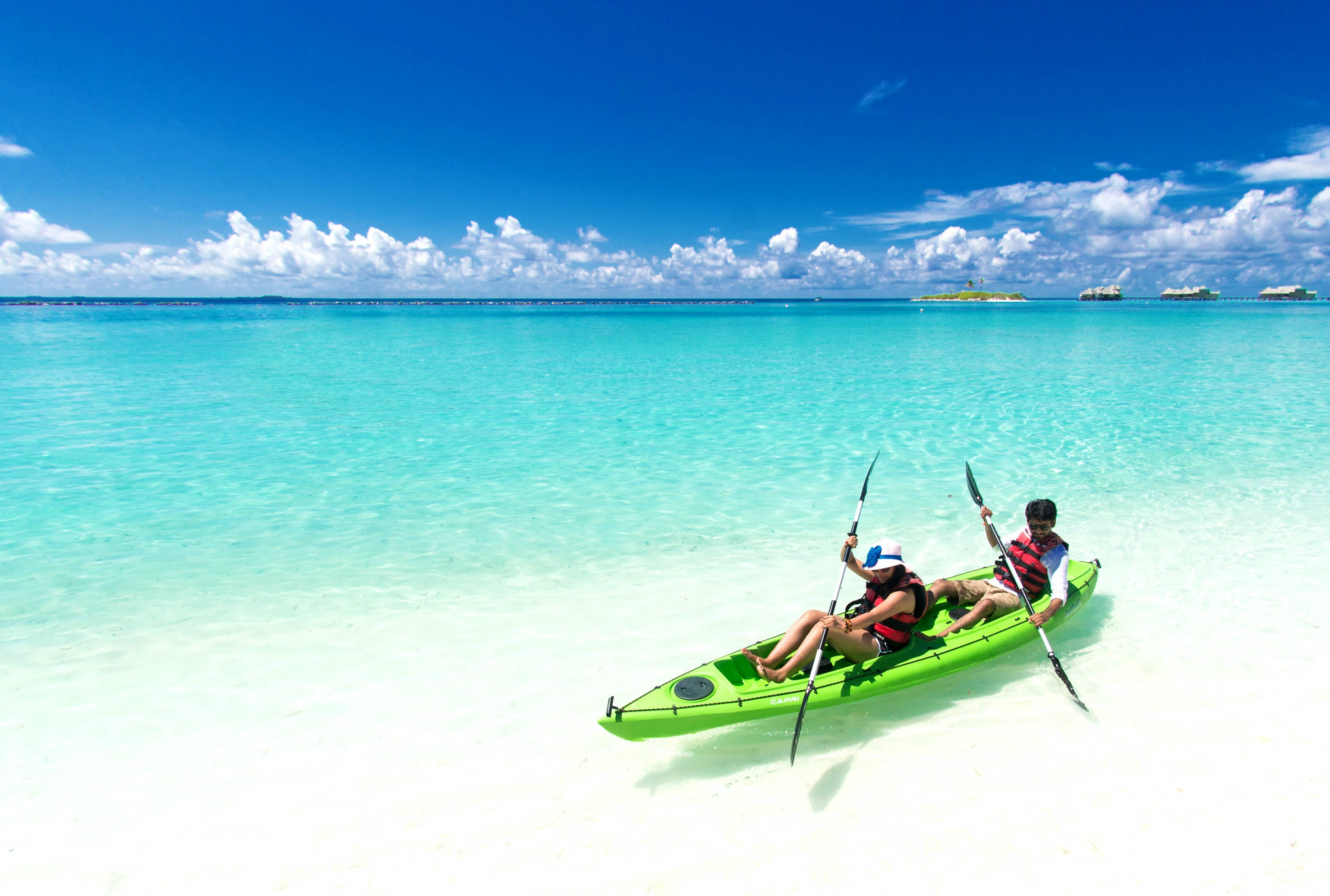 bright green kayak, crystal clear turquoise waters, white sandy beach, 2K Desktop Wallpaper