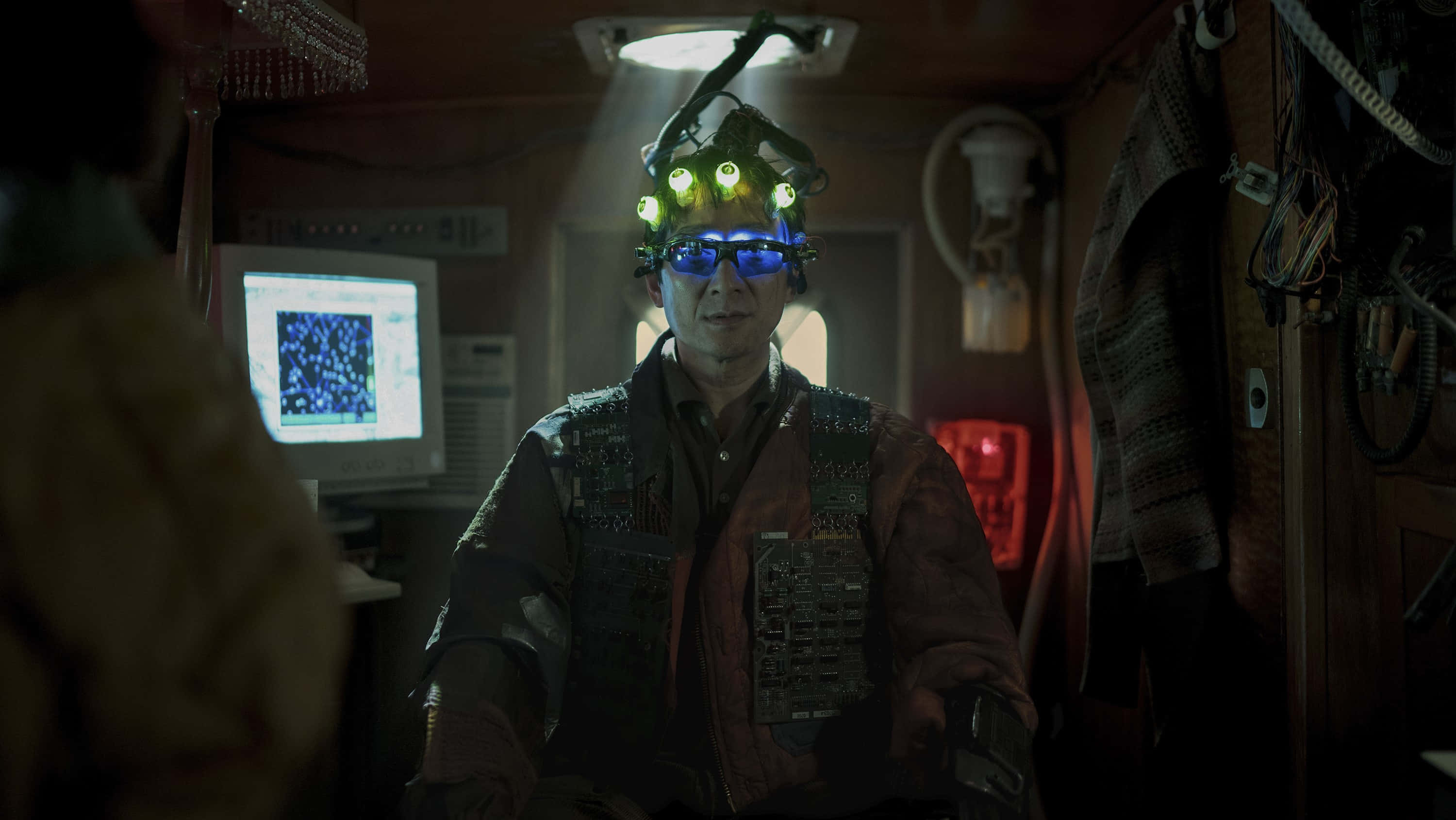 Ke Huy Quan, dimly lit cockpit, glowing headgear, 2K Desktop Wallpaper