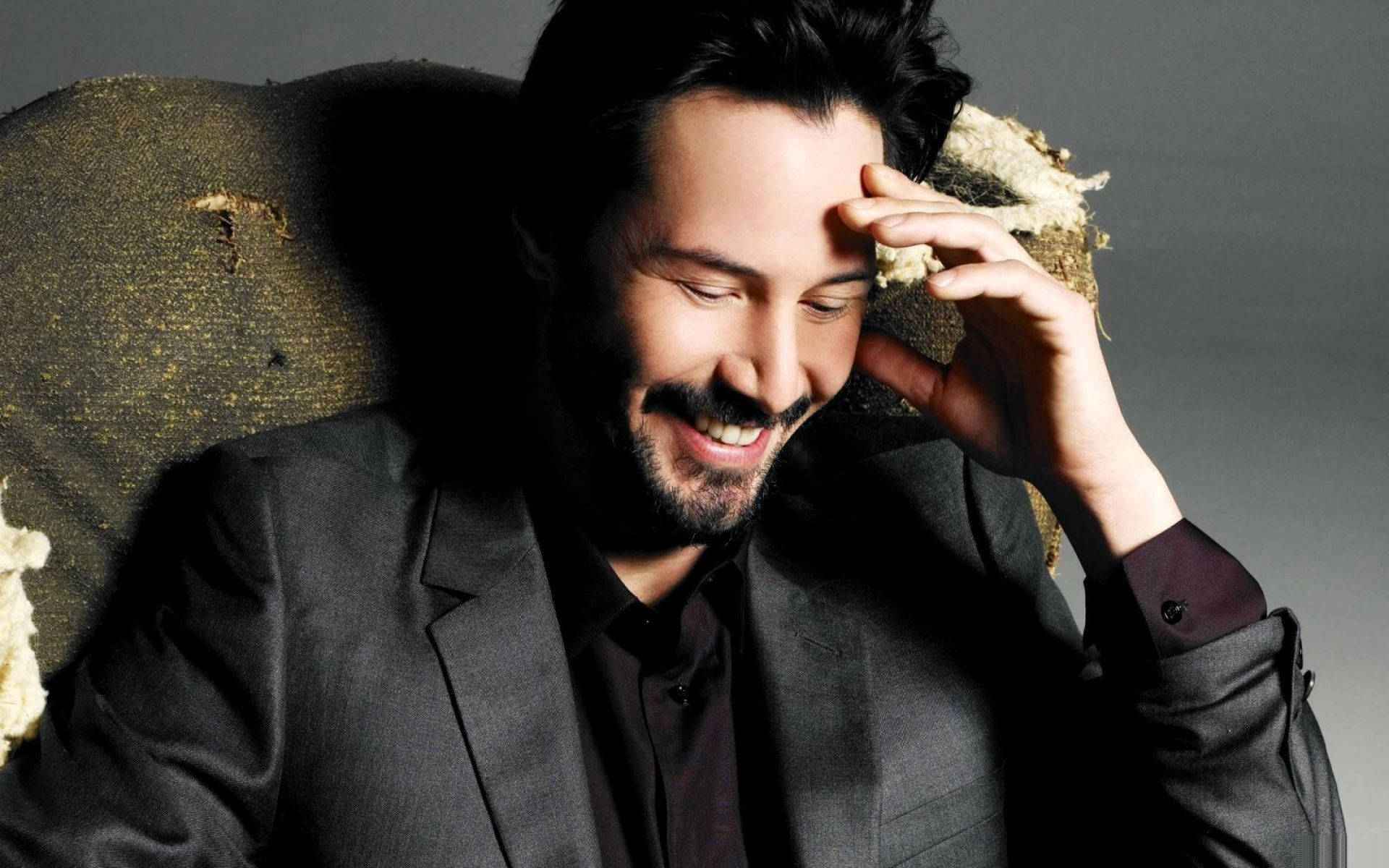 Keanu Reeves, dark suit, worn textured chair, Full HD Desktop Wallpaper