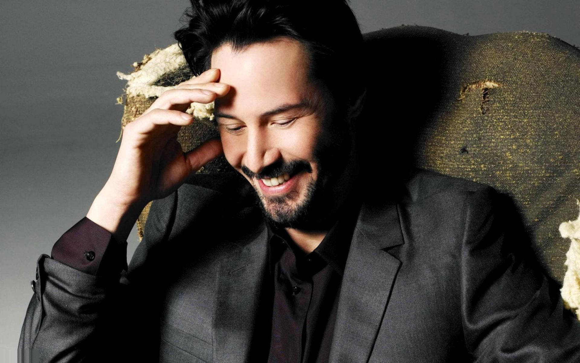 Keanu Reeves, dark suit, worn textured chair, Full HD Desktop Wallpaper