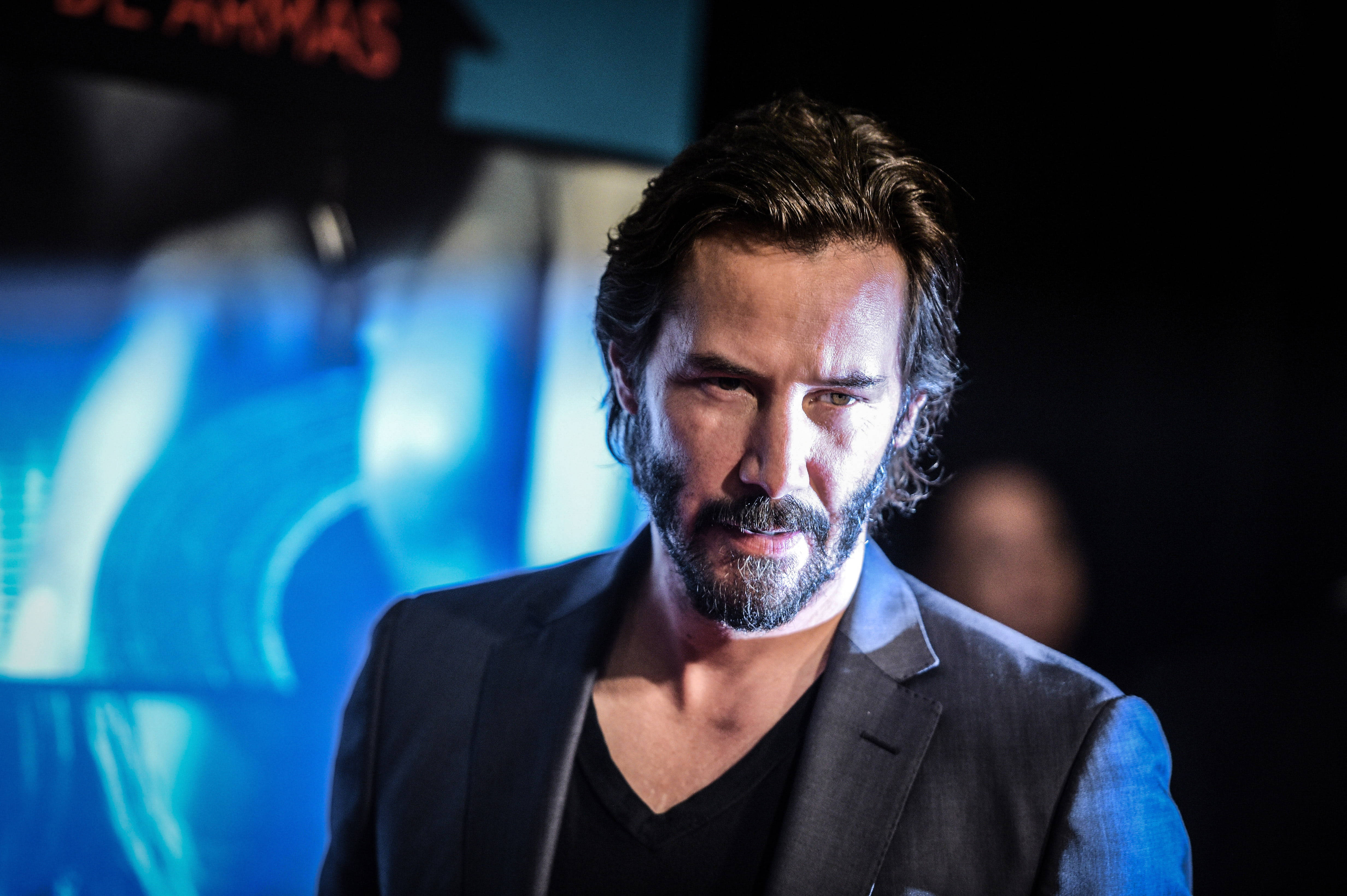 Keanu Reeves, dark suit, glowing blue background, 4K Desktop Wallpaper