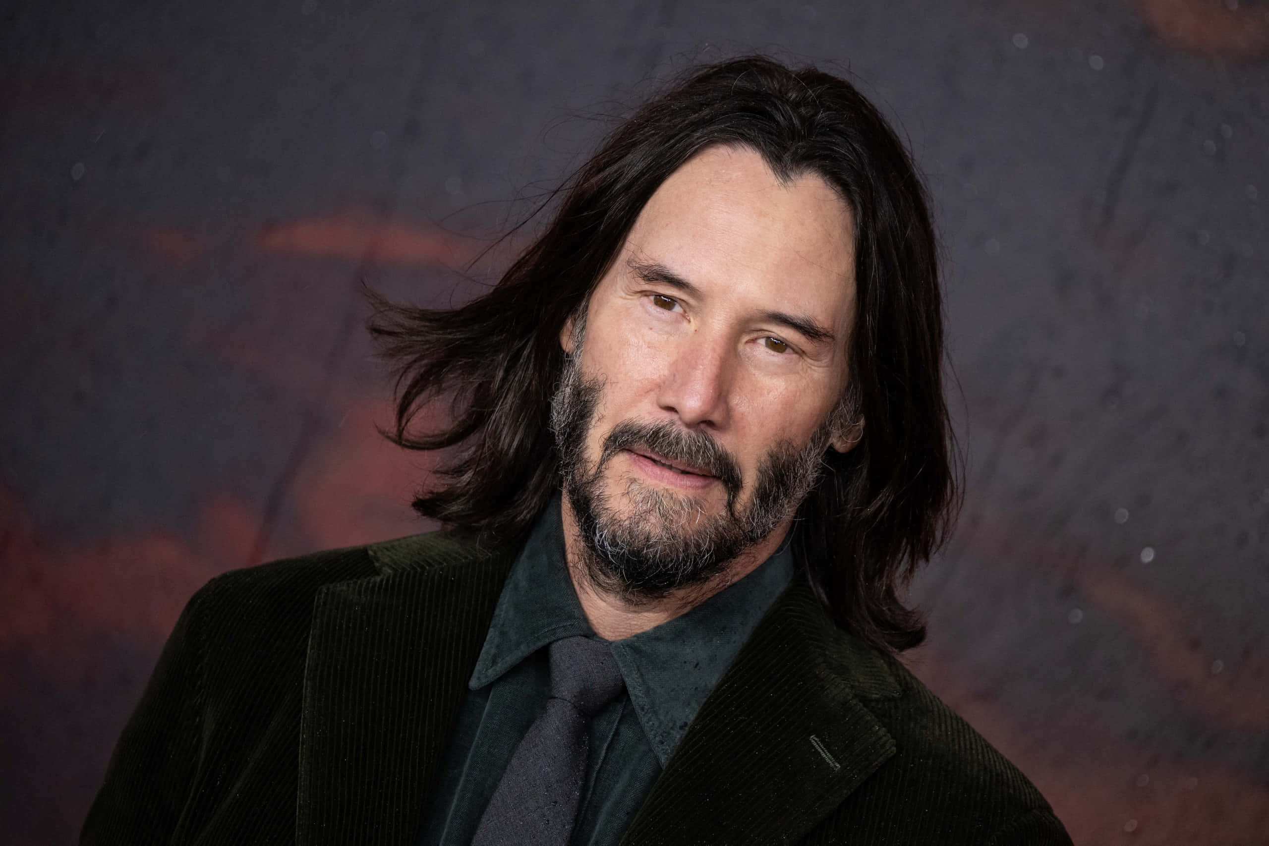 Keanu Reeves, dark corduroy suit, red and gray tones, 2K Desktop Wallpaper
