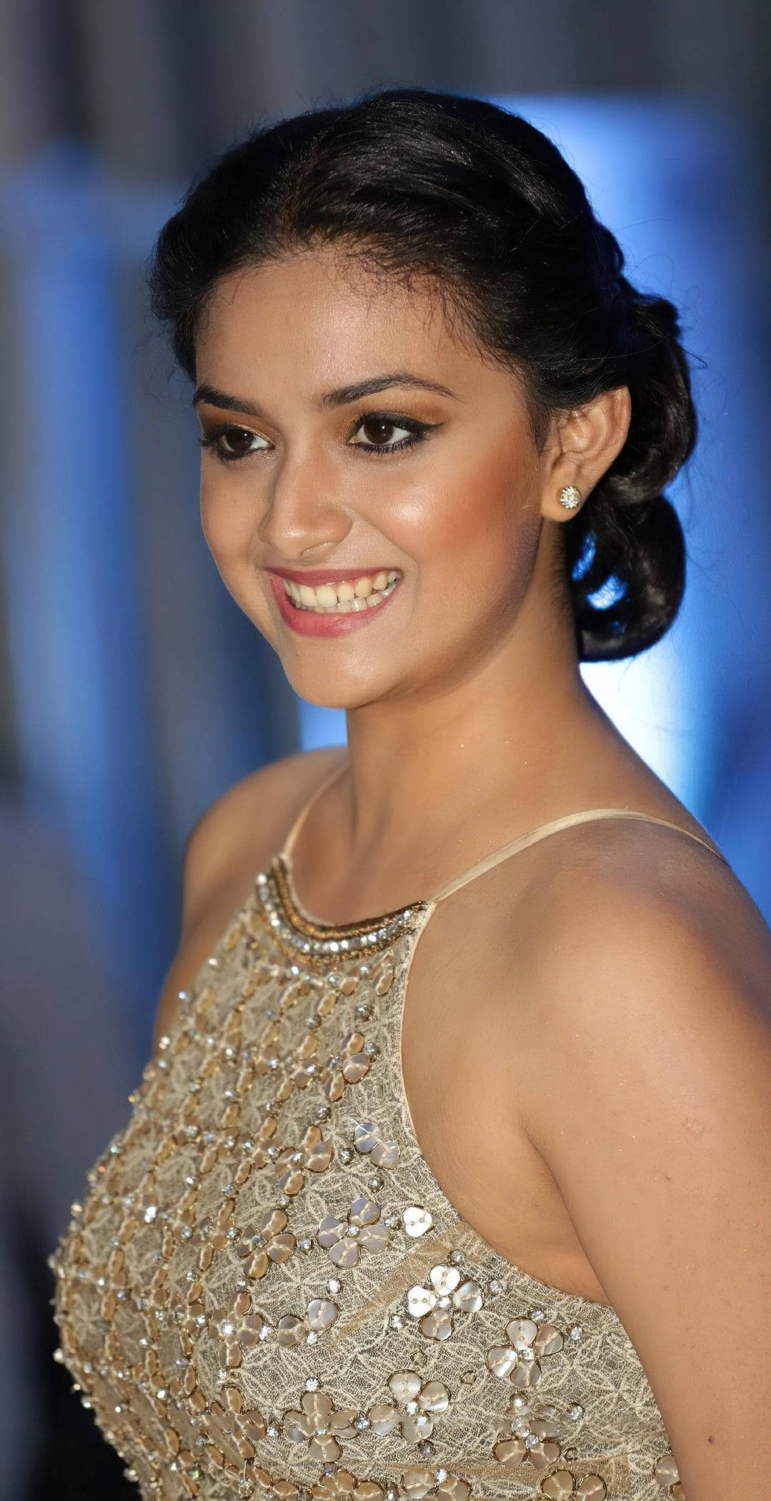Keerthi Suresh, sparkling gold beaded gown, soft blue blurred background, Full HD Phone Wallpaper