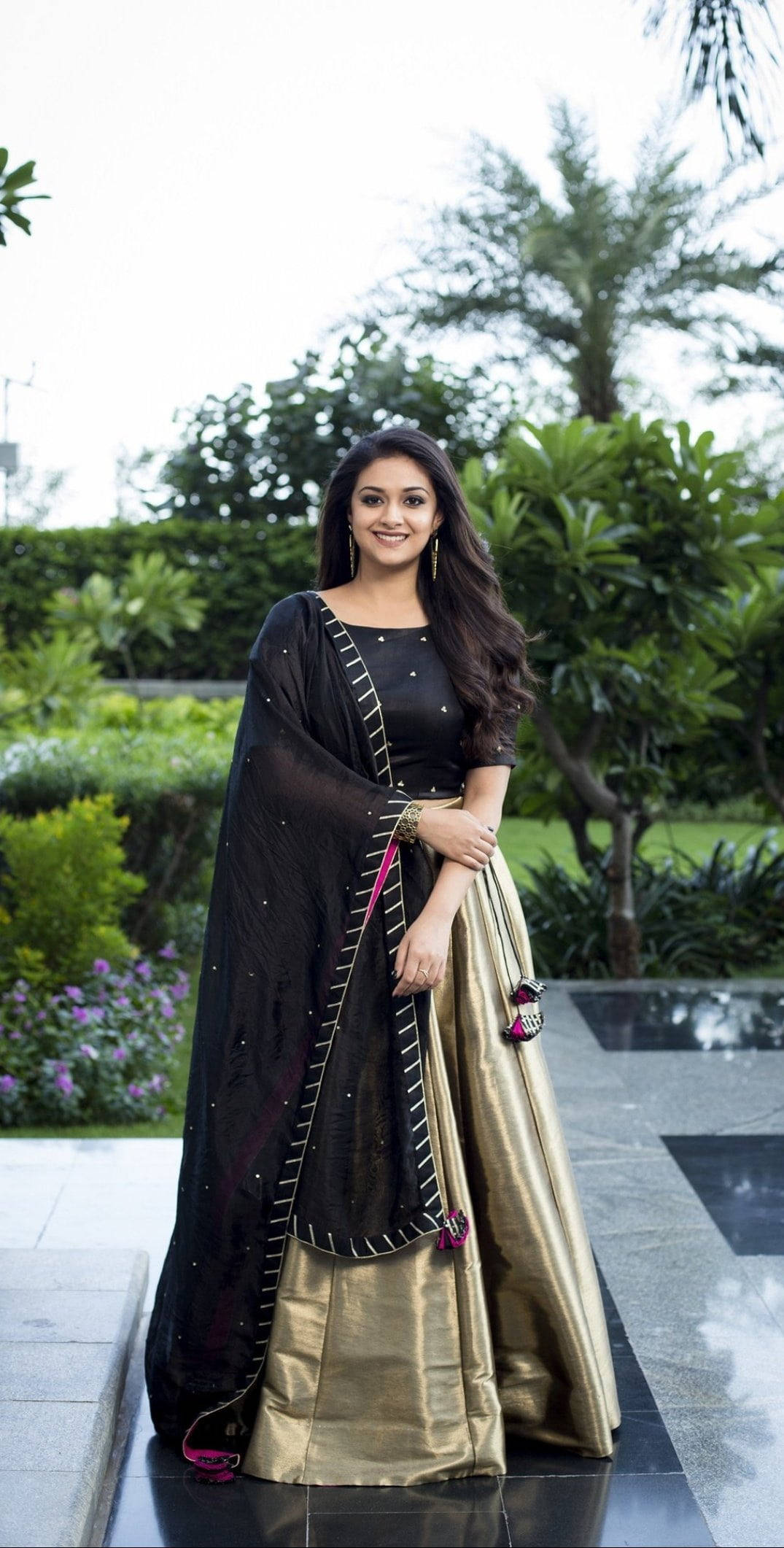 Keerthi Suresh, black and gold traditional outfit, lush green garden, Full HD Phone Wallpaper