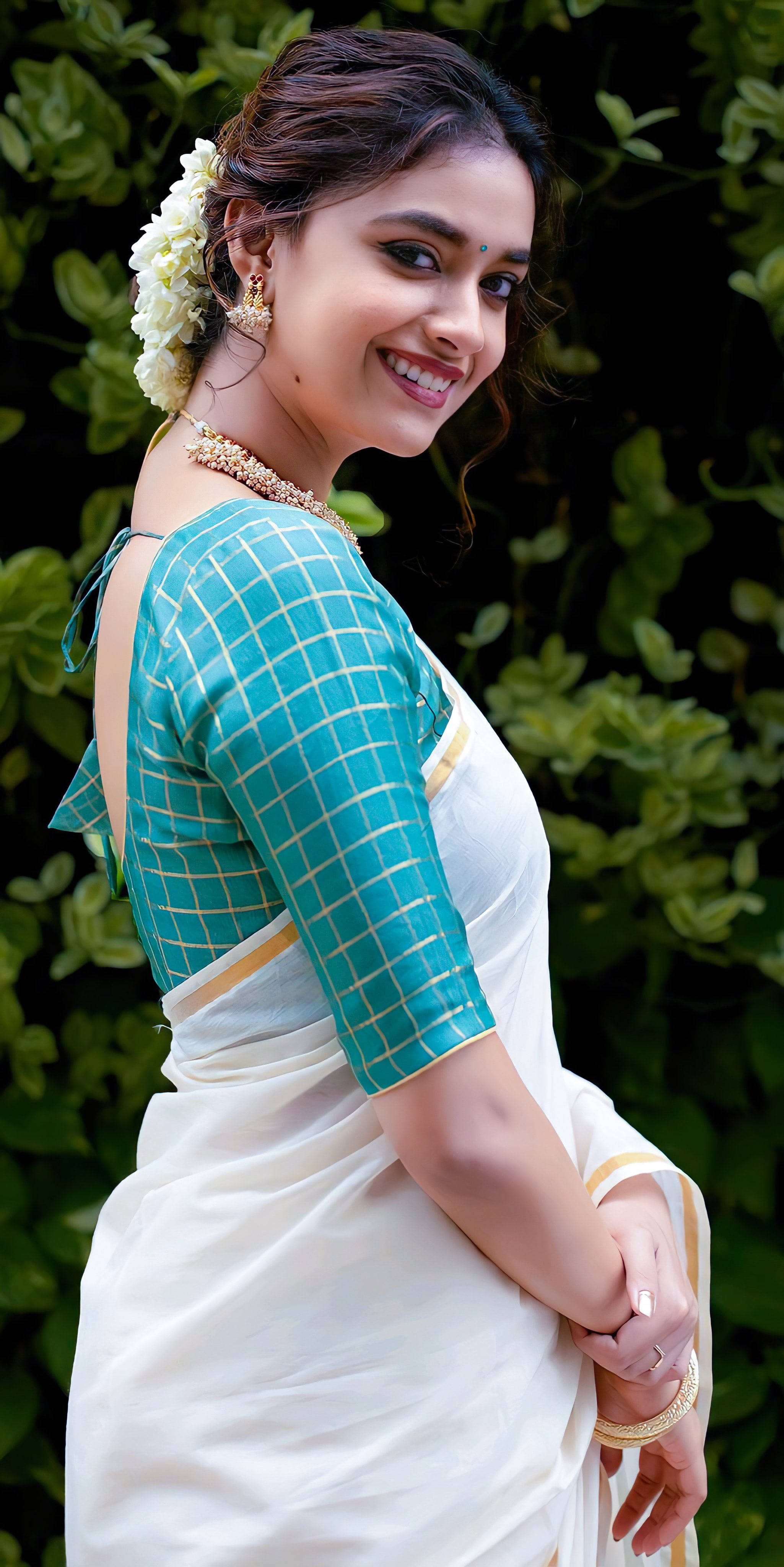 Keerthi Suresh, teal and white saree, lush green foliage, 4K Phone Wallpaper