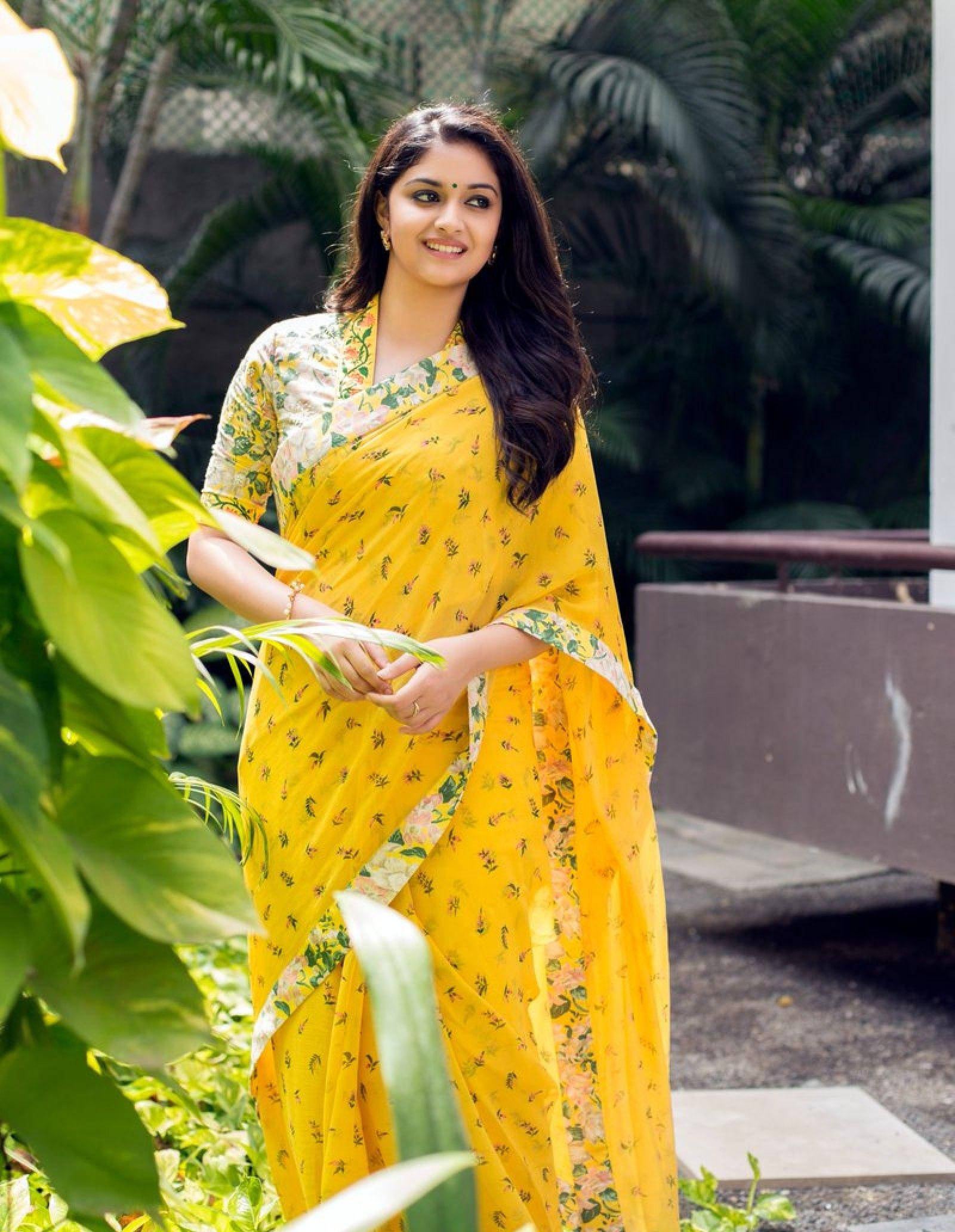 Keerthi Suresh, vibrant yellow floral saree, lush green foliage, Full HD Phone Wallpaper