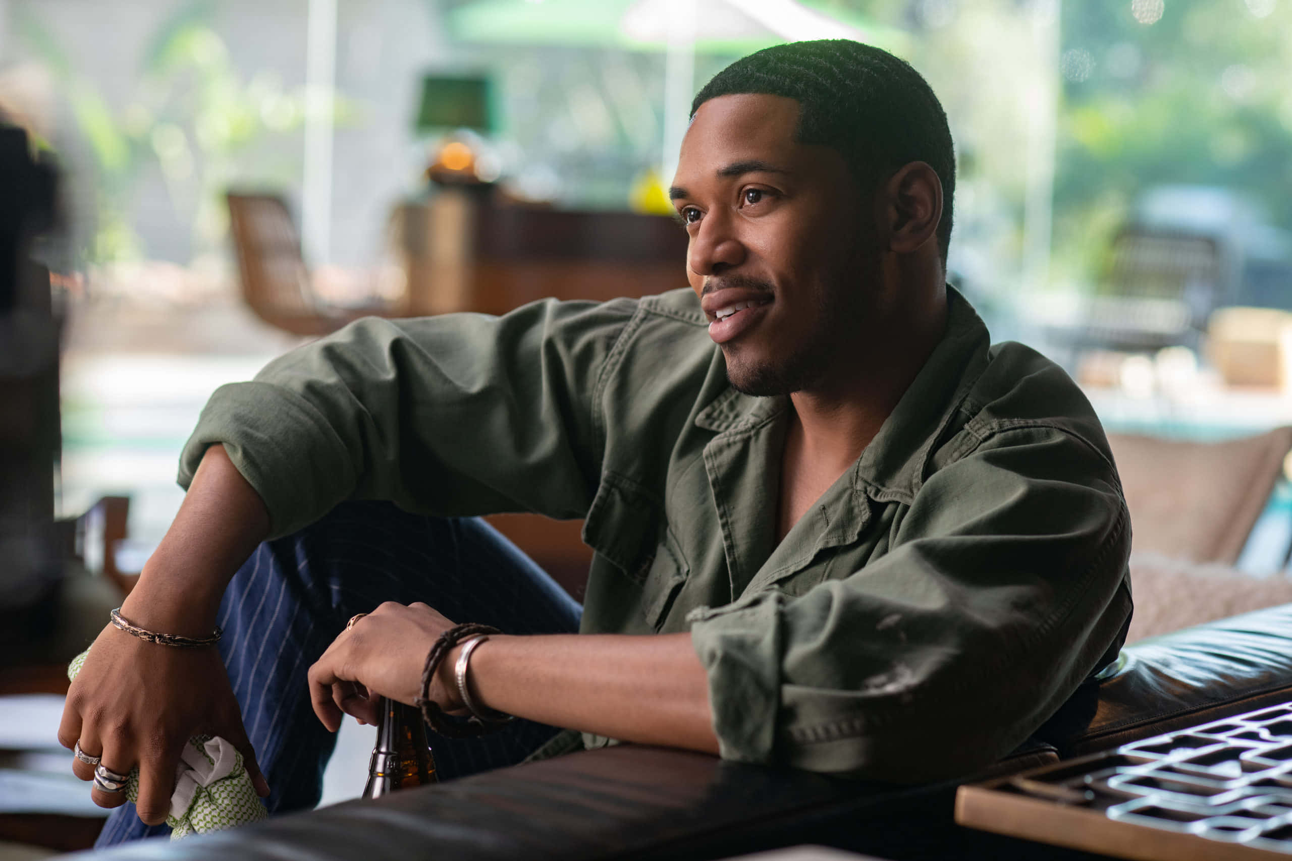 Kelvin Harrison Jr, green shirt, wooden table, 2K Desktop Wallpaper