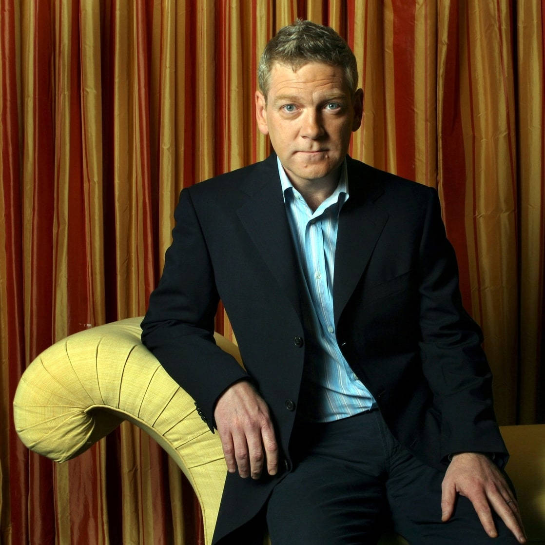 Kenneth Branagh, dark suit, curved yellow chair, SD Desktop Wallpaper