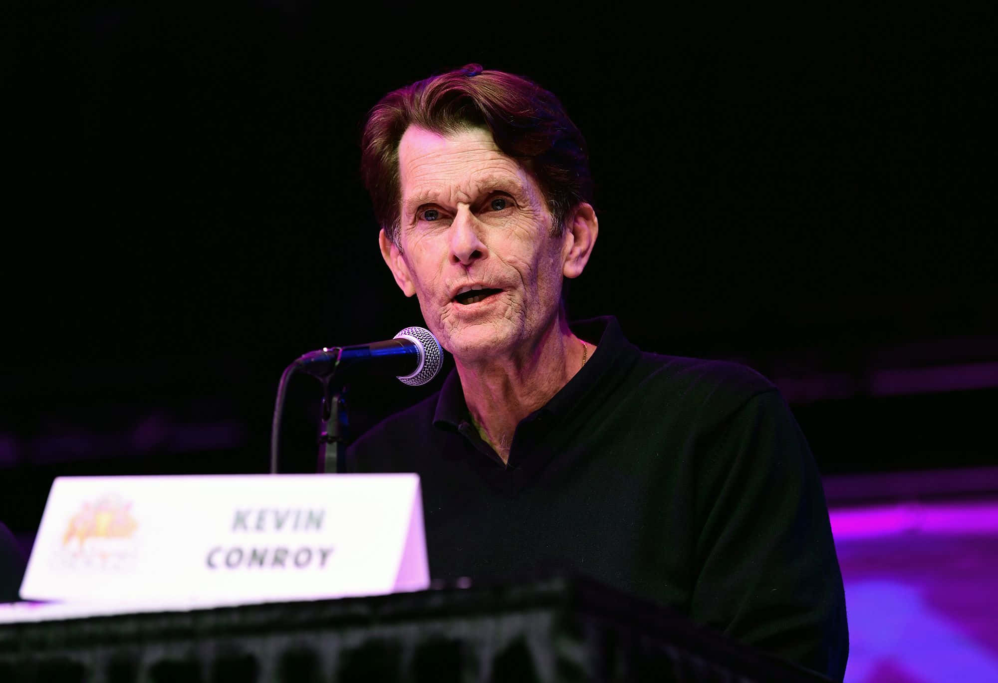 Kevin Conroy, dimly lit event, purple stage lighting, Full HD Desktop Wallpaper