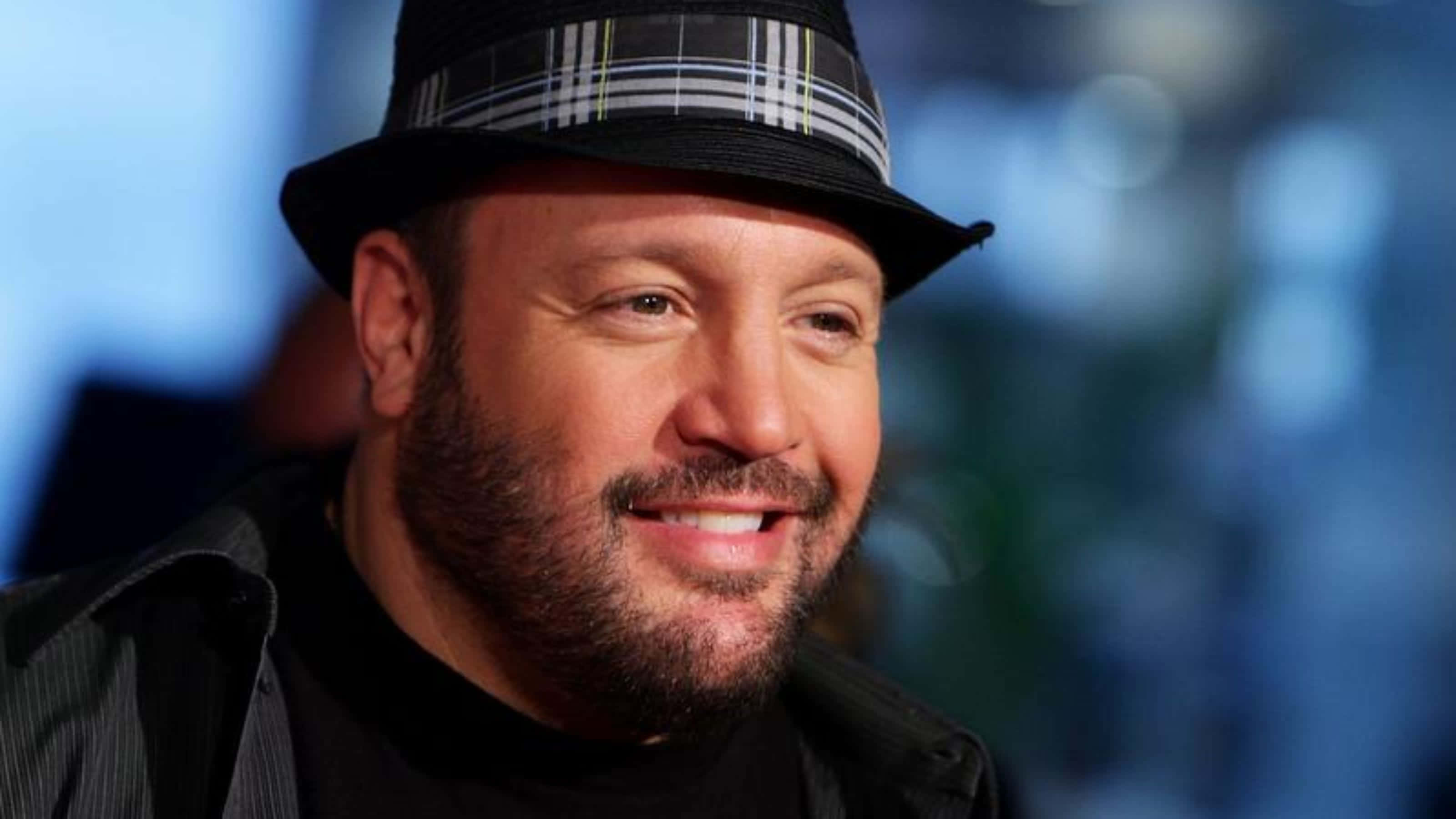 Kevin James, black plaid fedora, blurred blue background, 2K Desktop Wallpaper