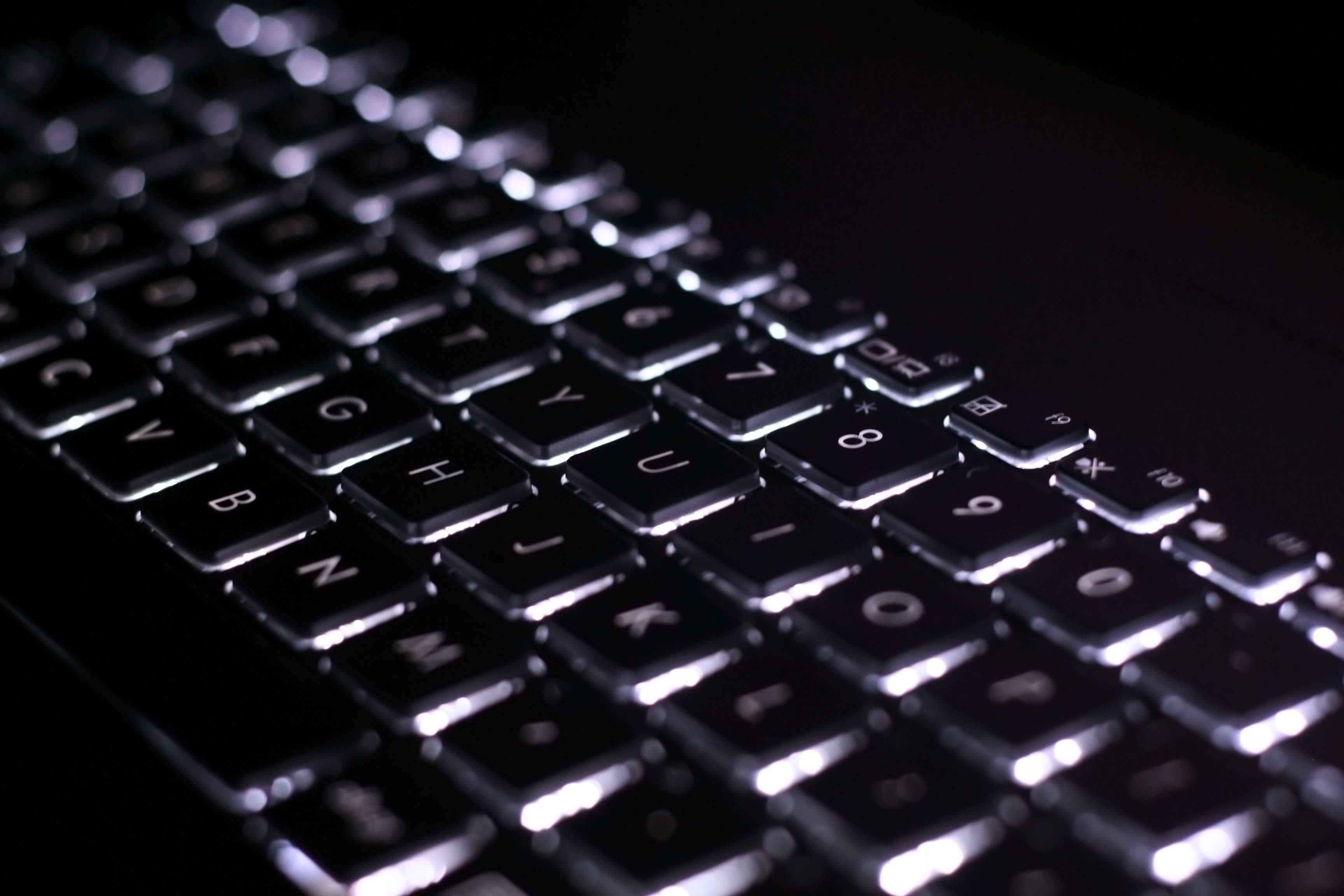 minimalistic backlit black keyboard, black keyboard, glowing white lettering, 2K Desktop Wallpaper