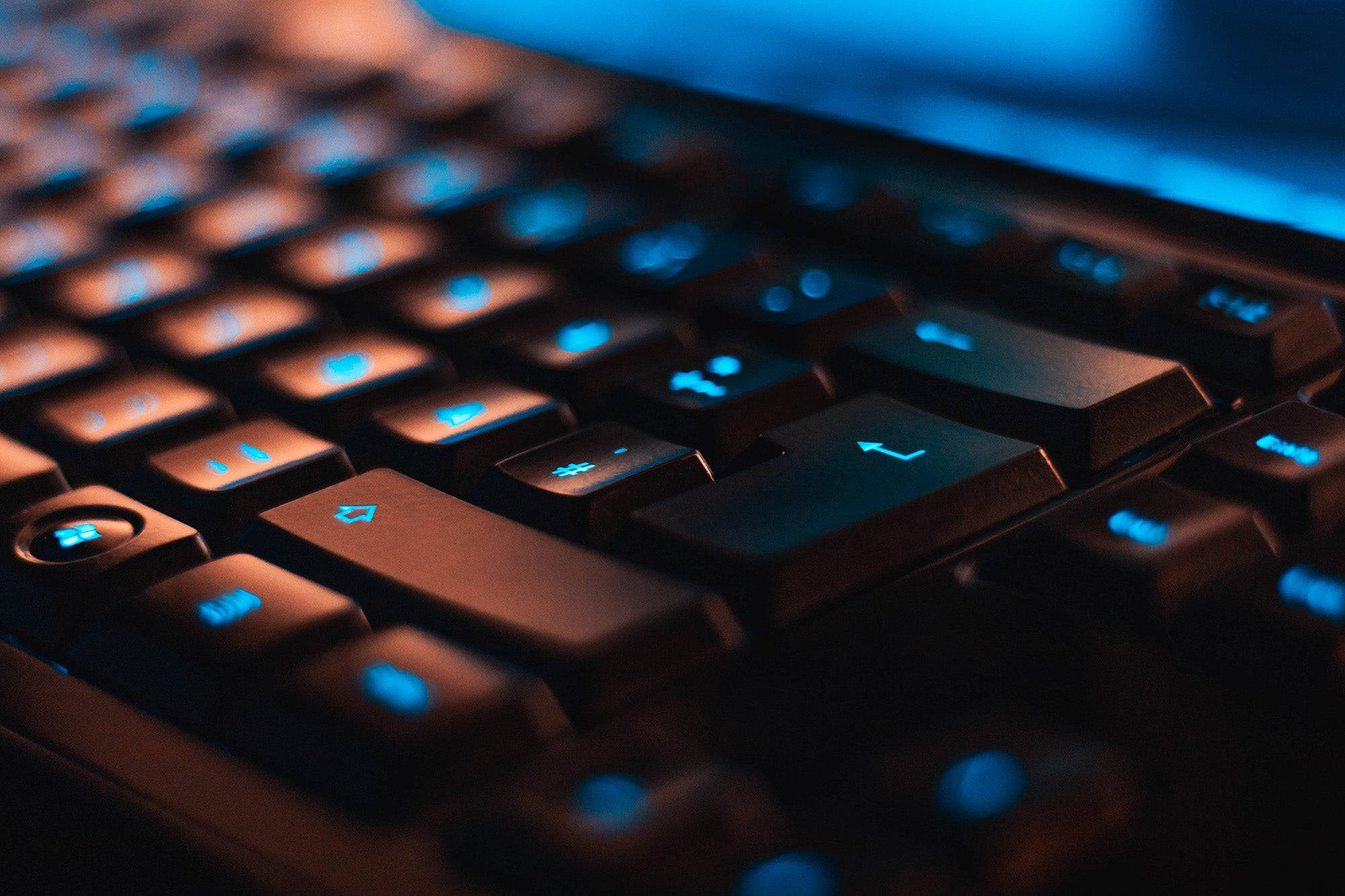 classic neon blue gaming keyboard, glowing blue backlighting, warm orange highlights, Full HD Desktop Wallpaper