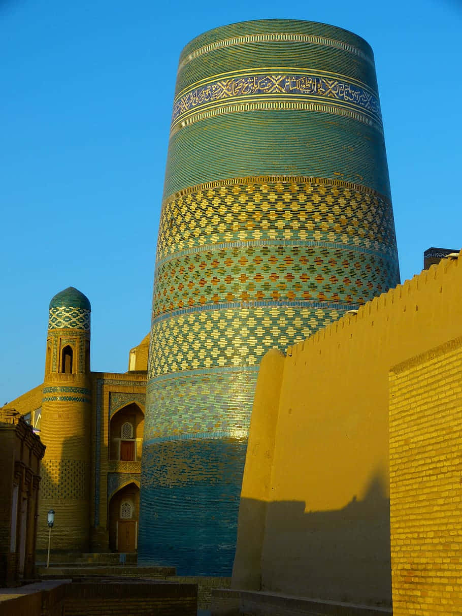 Khiva, thick green tower, turquoise and gold tiled minaret, SD Phone Wallpaper