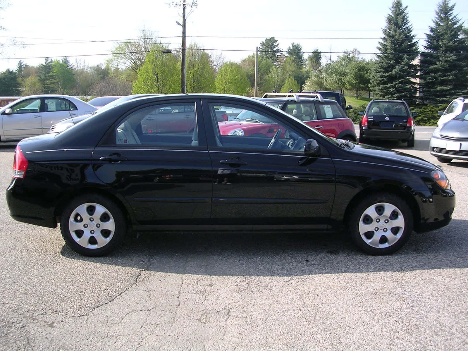 Kia Spectra, sleek black sedan, sunlit lot, HD Desktop Wallpaper