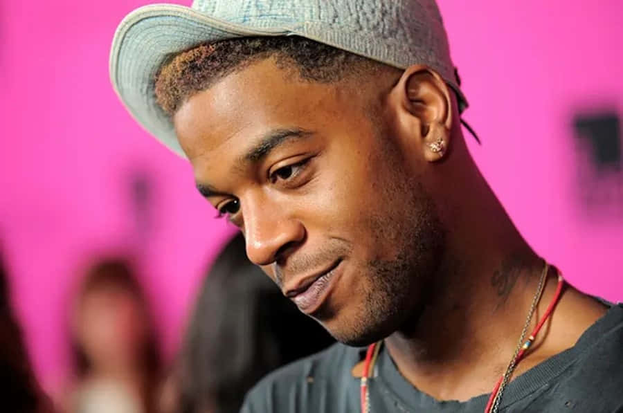 Kid Cudi, light blue cap, vibrant pink background, SD Desktop Wallpaper