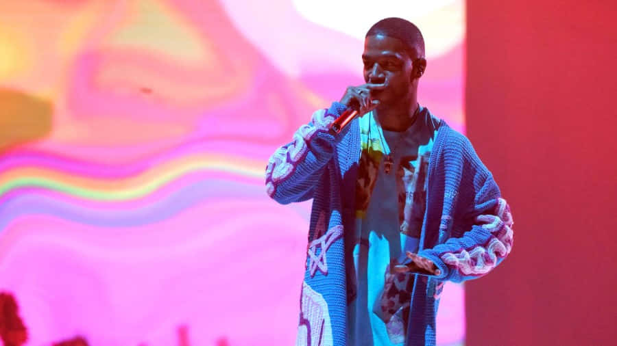 Kid Cudi, blue patterned cardigan, pink and yellow abstract light backdrop, SD Desktop Wallpaper