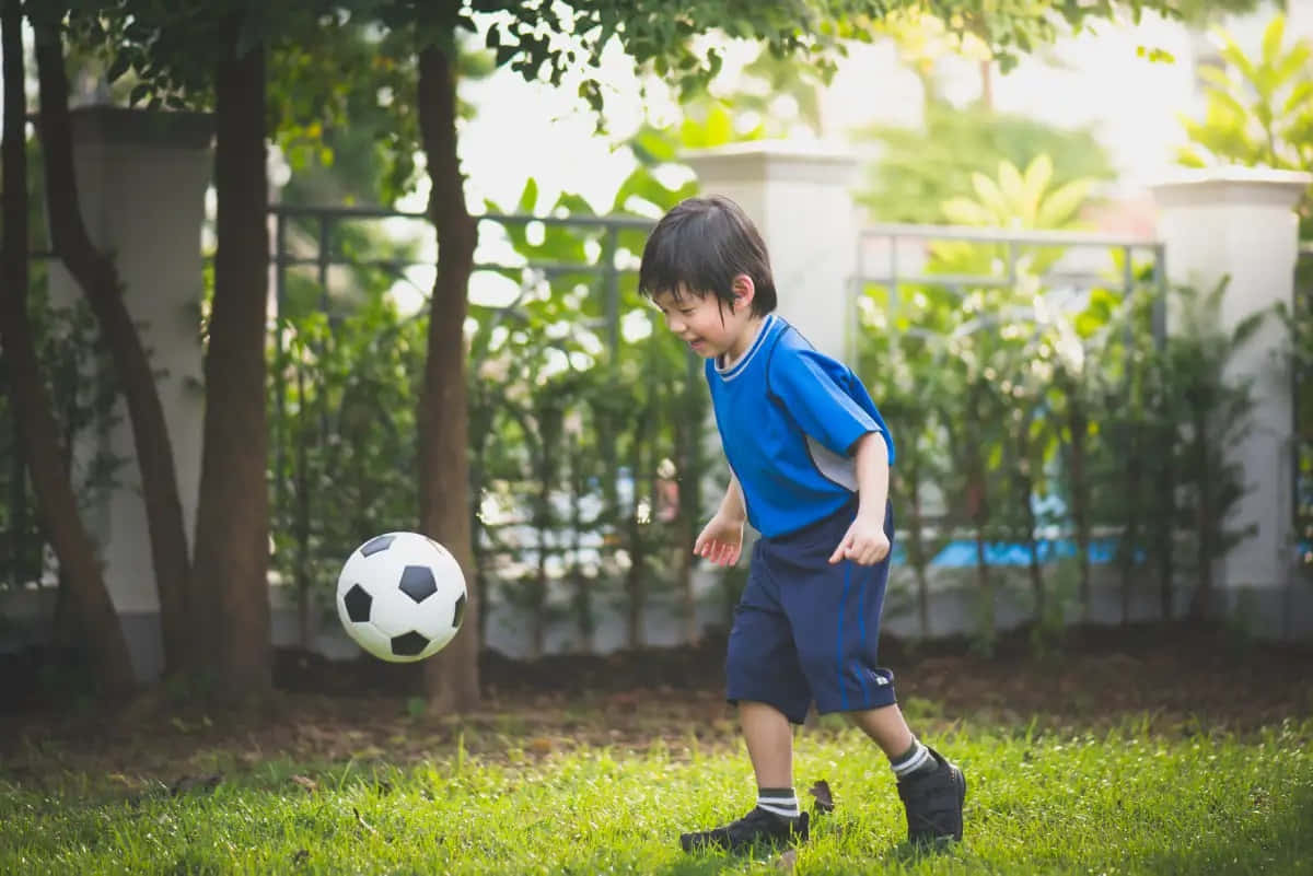 young boy, blue uniform, soccer ball, SD Desktop Wallpaper