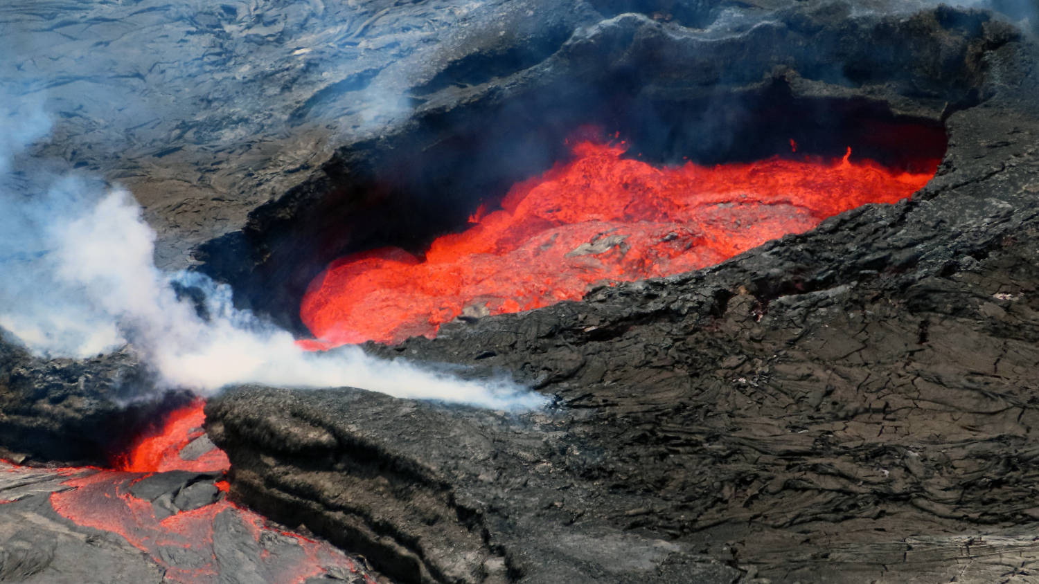 Kilauea Volcano, glowing red lava, dark rugged terrain, HD Desktop Wallpaper