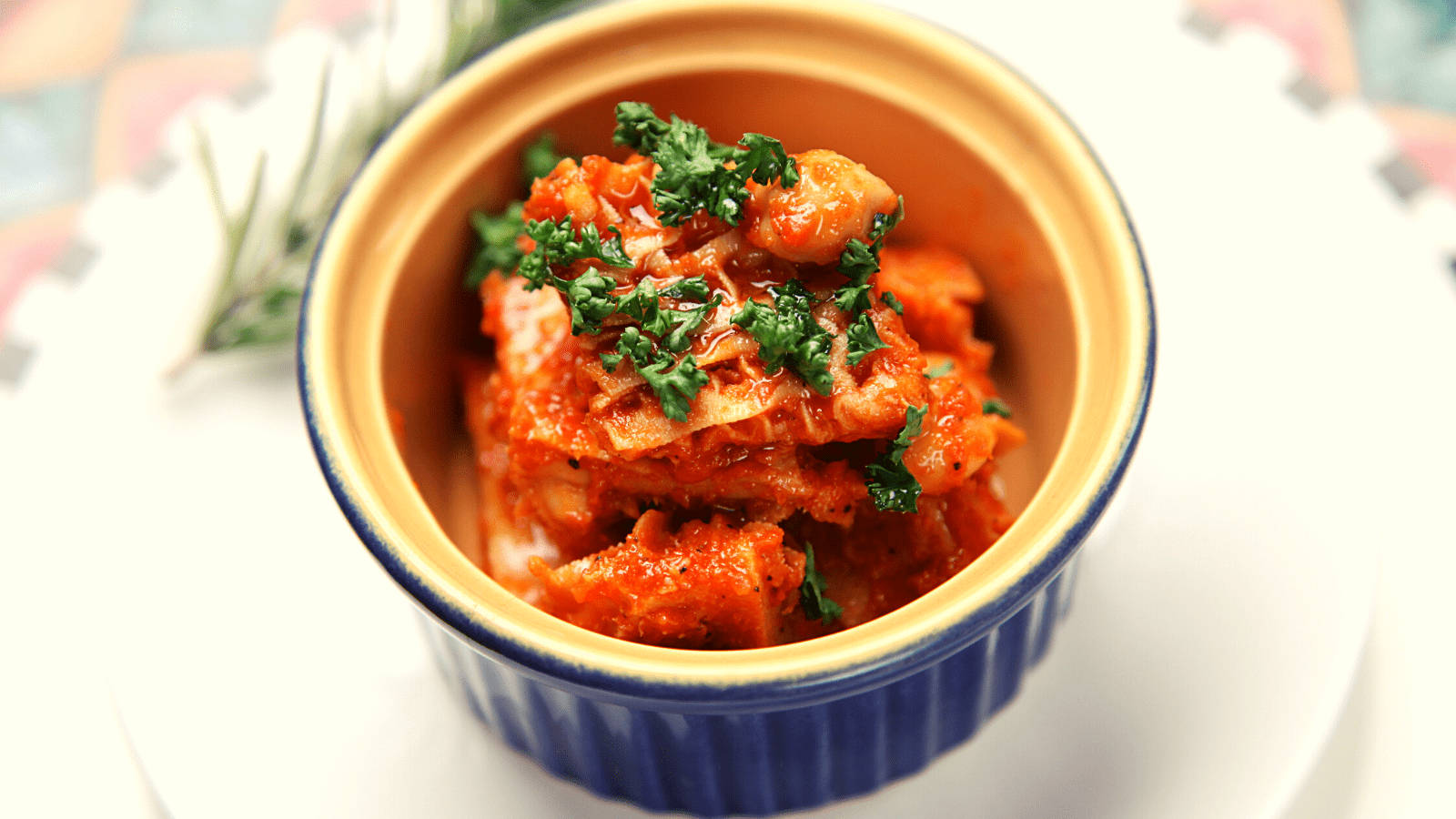 Korean orange dish kimchi, vibrant orange stew, fresh green herbs, HD Desktop Wallpaper