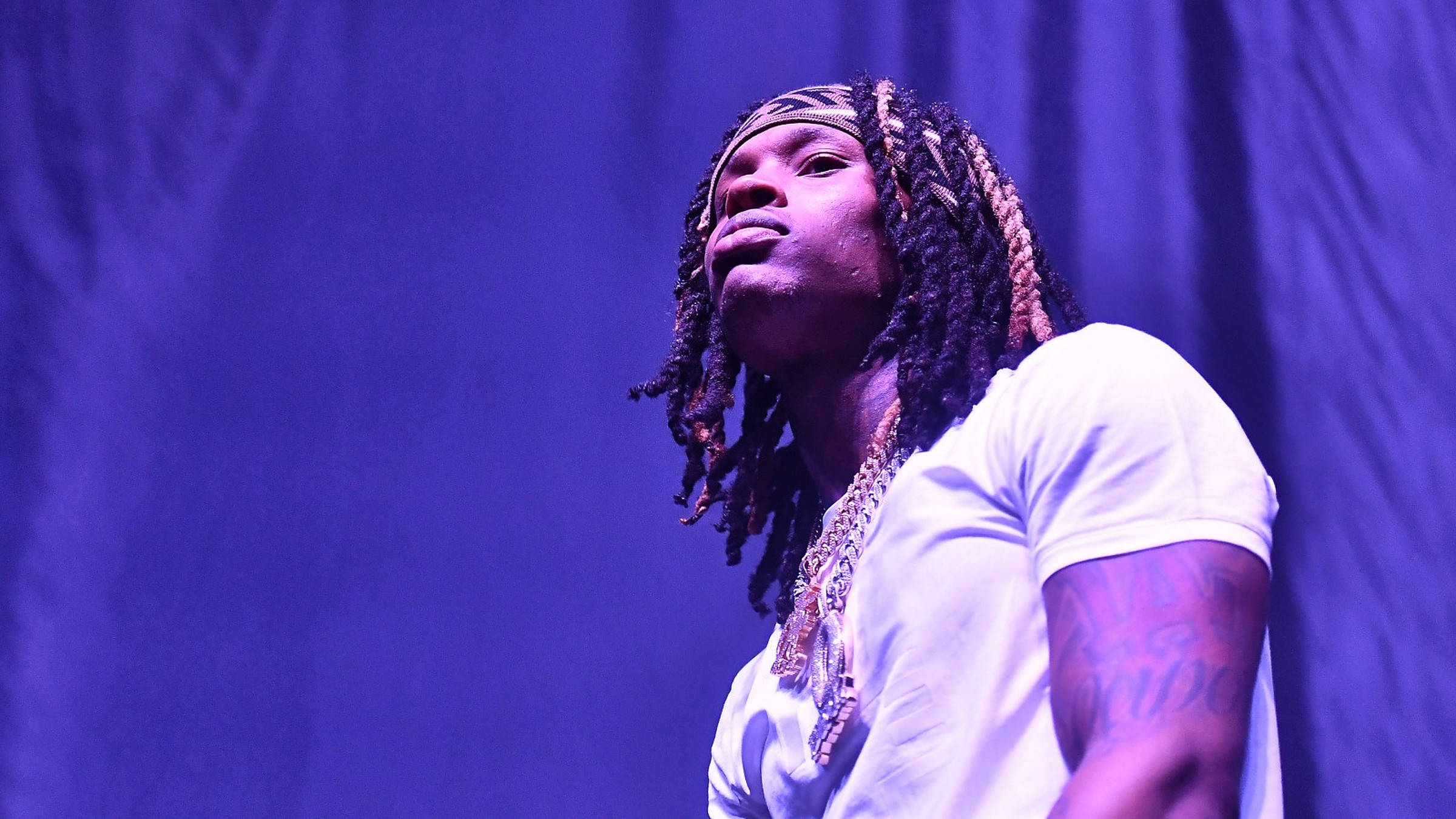 King Von, purple-lit stage spotlight, white t-shirt, Full HD Desktop Wallpaper