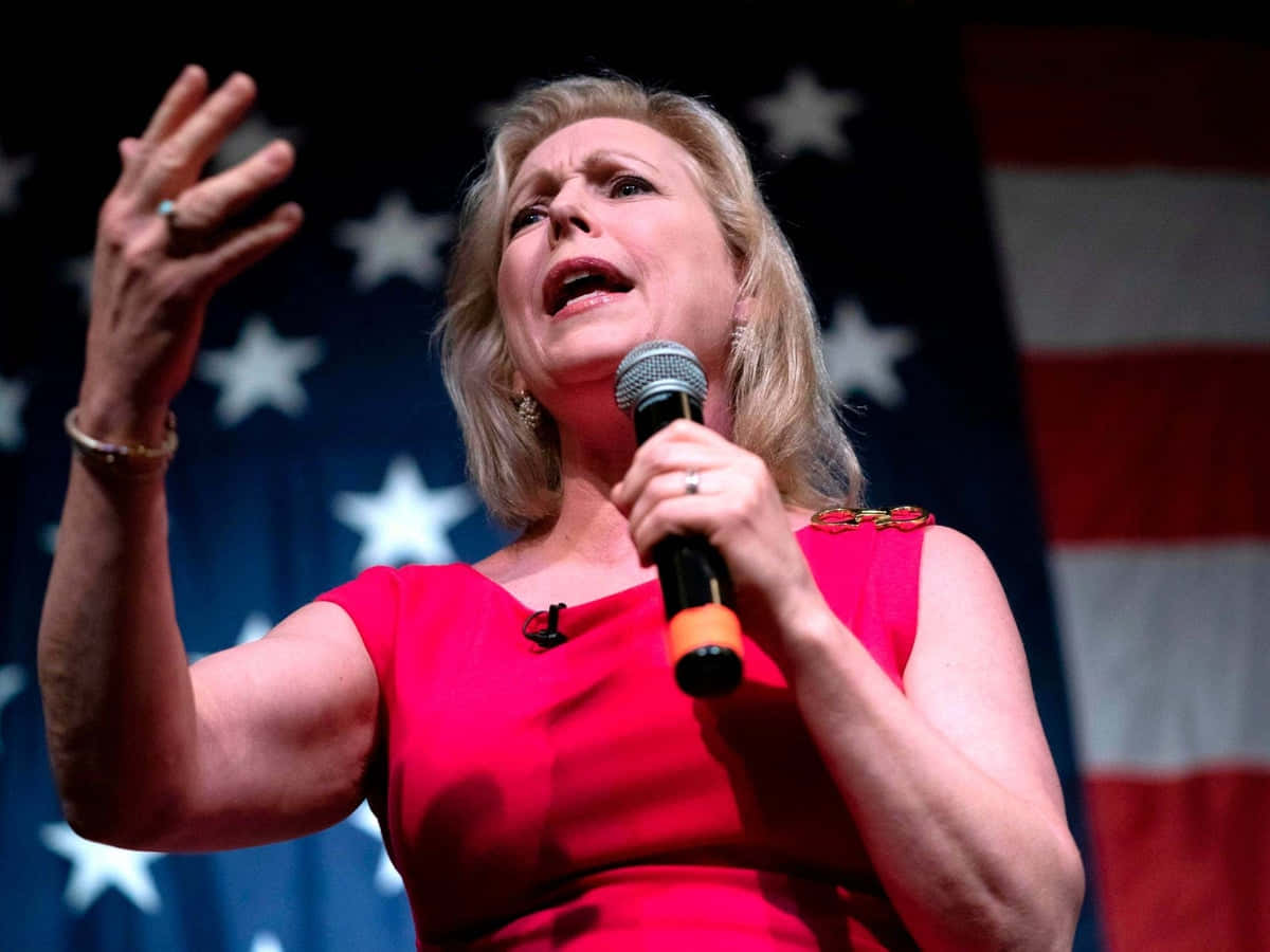 Kirsten Gillibrand, red dress, microphone, SD Desktop Wallpaper