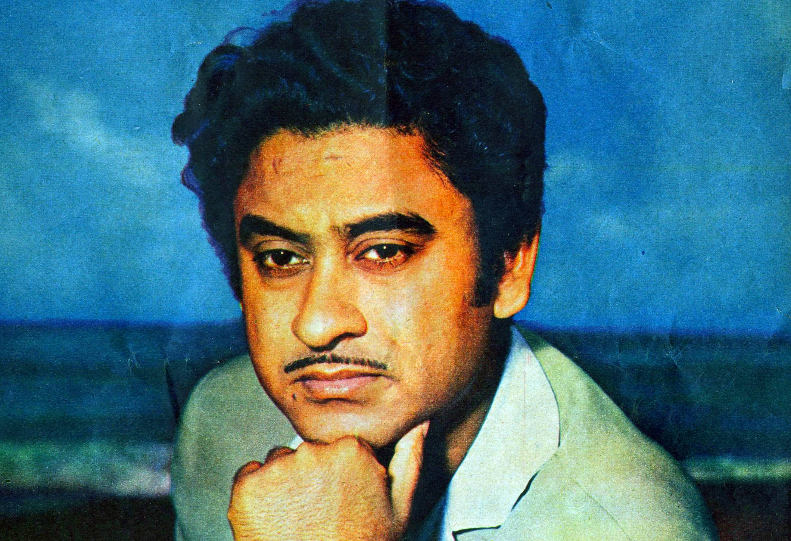 Kishore Kumar, hand on chin, dark curly hair, 2K Desktop Wallpaper