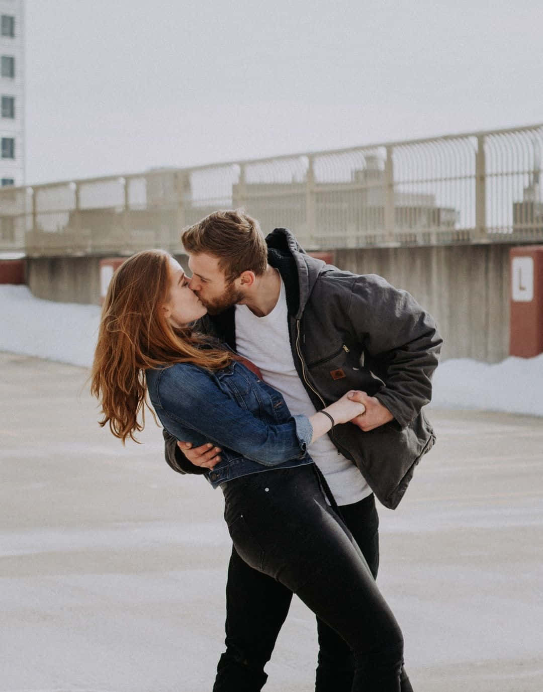 Adorable Couple Kissing Lips, snowy rooftop, urban buildings, HD Phone Wallpaper
