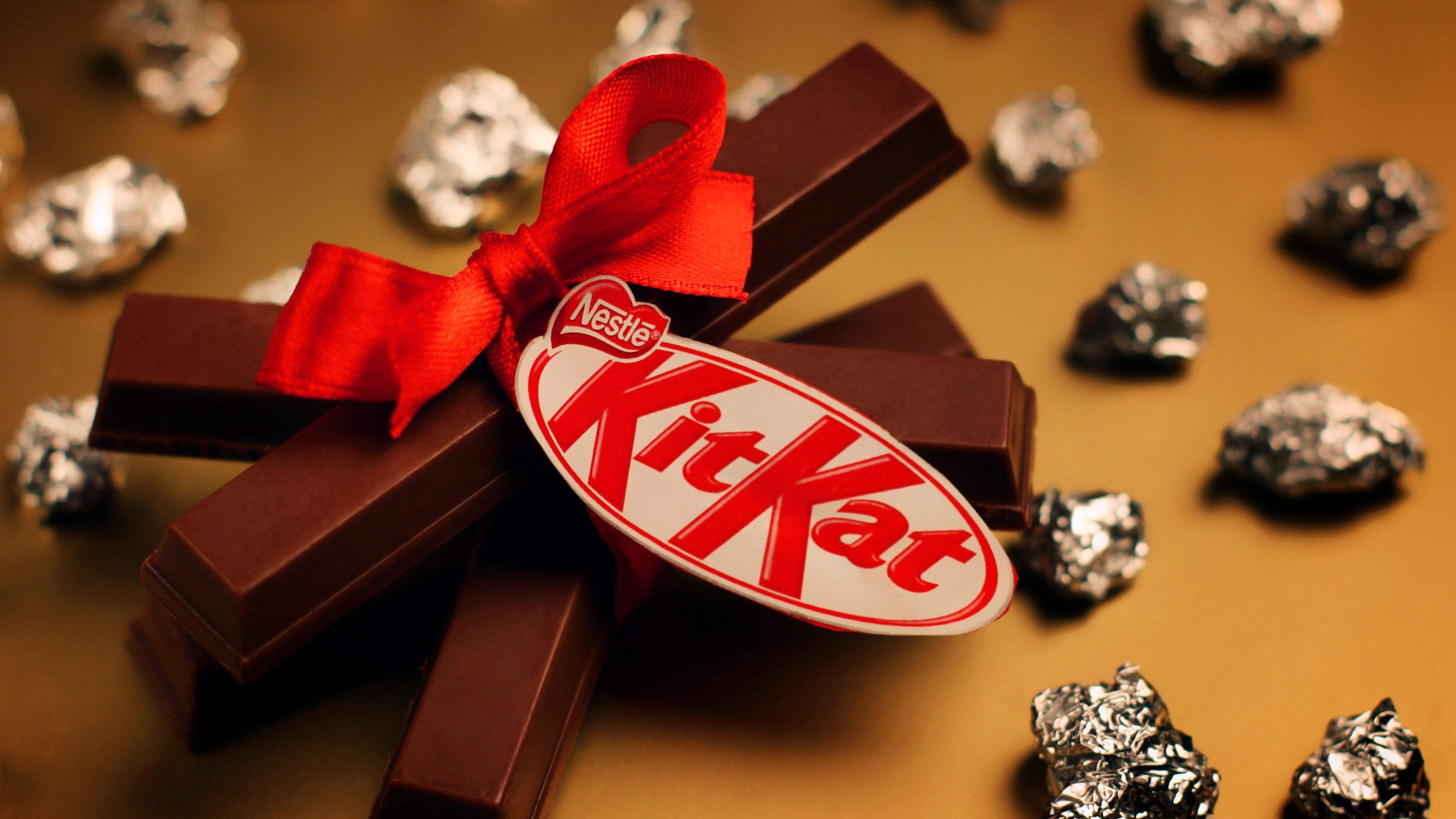 Kit Kat, red ribbon, foiled-wrapped pieces, 2K Desktop Wallpaper