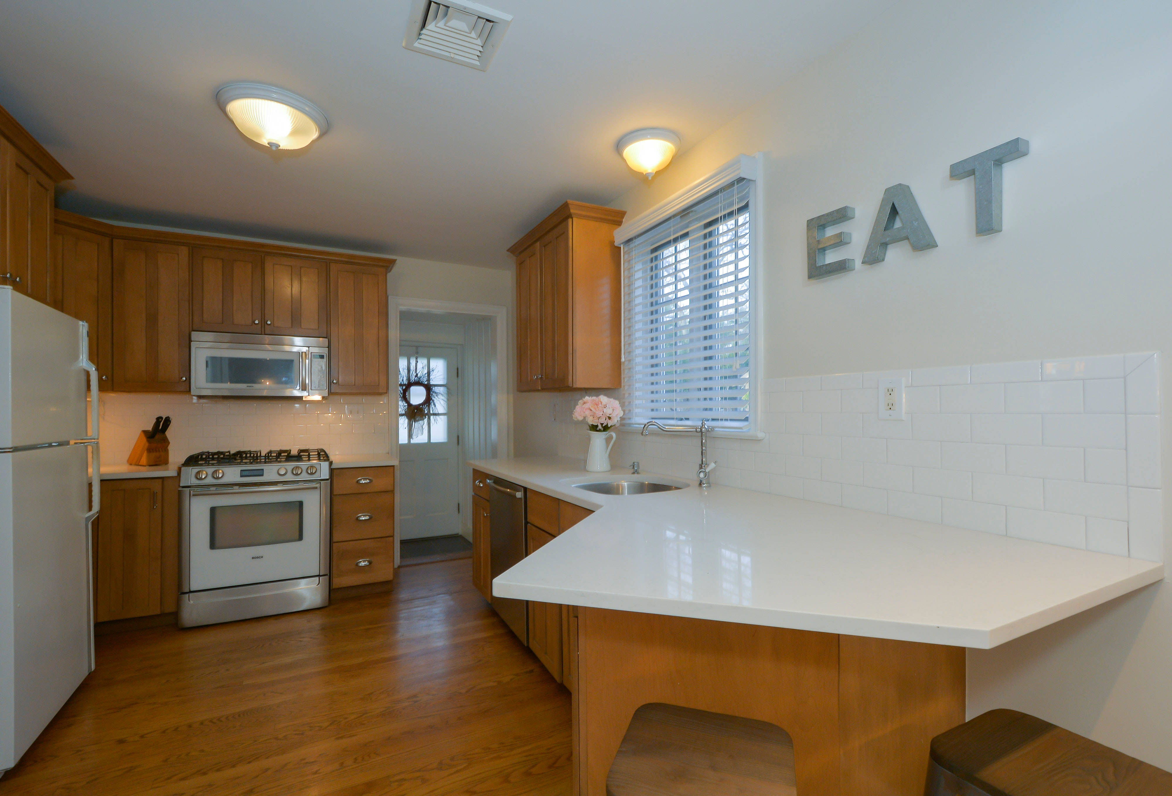 modern wood style kitchen interior, wooden cabinets, white countertops, 4K Desktop Wallpaper