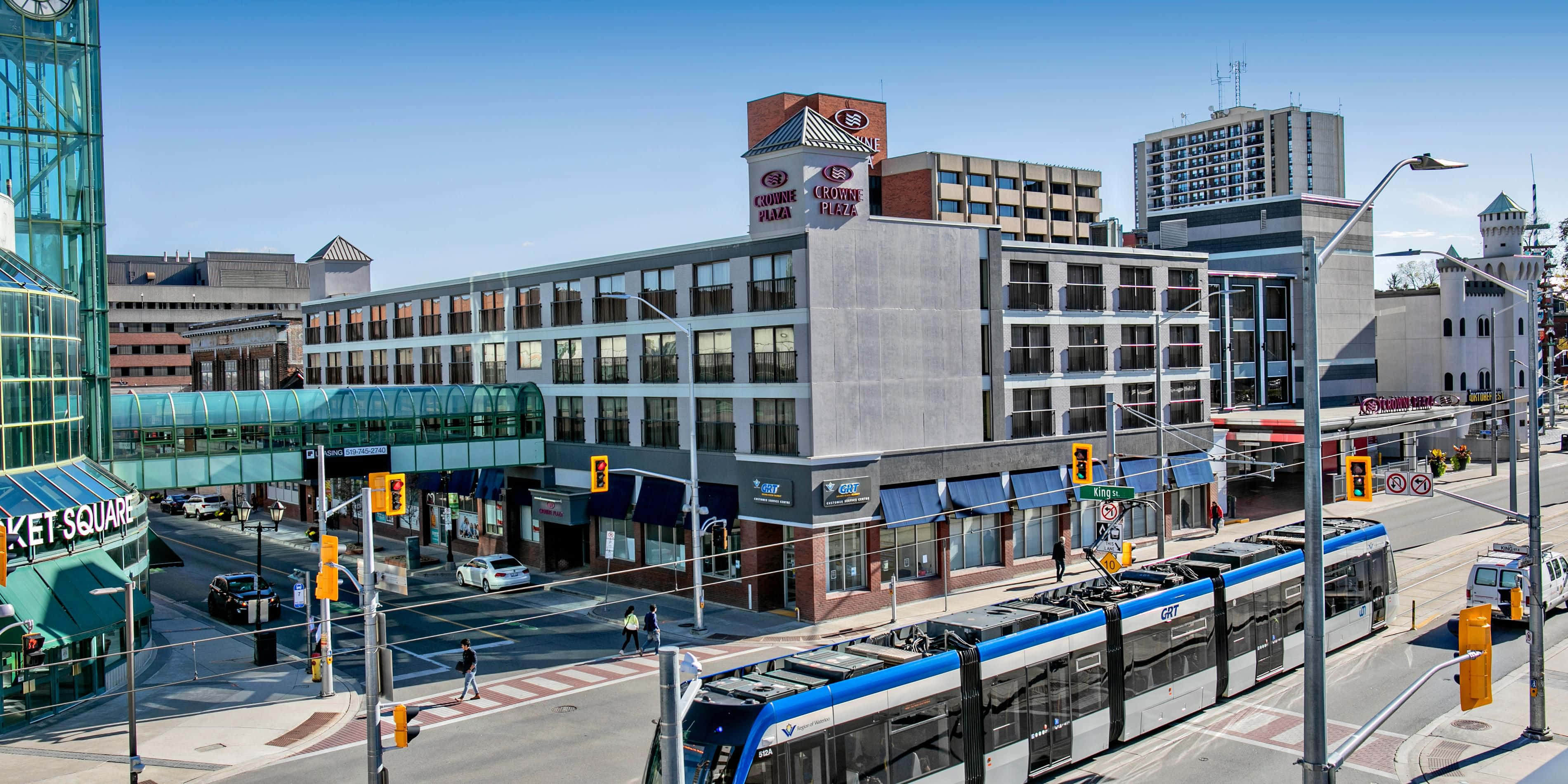 Kitchener, downtown street view, blue and silver light rail train, 2K Desktop Wallpaper