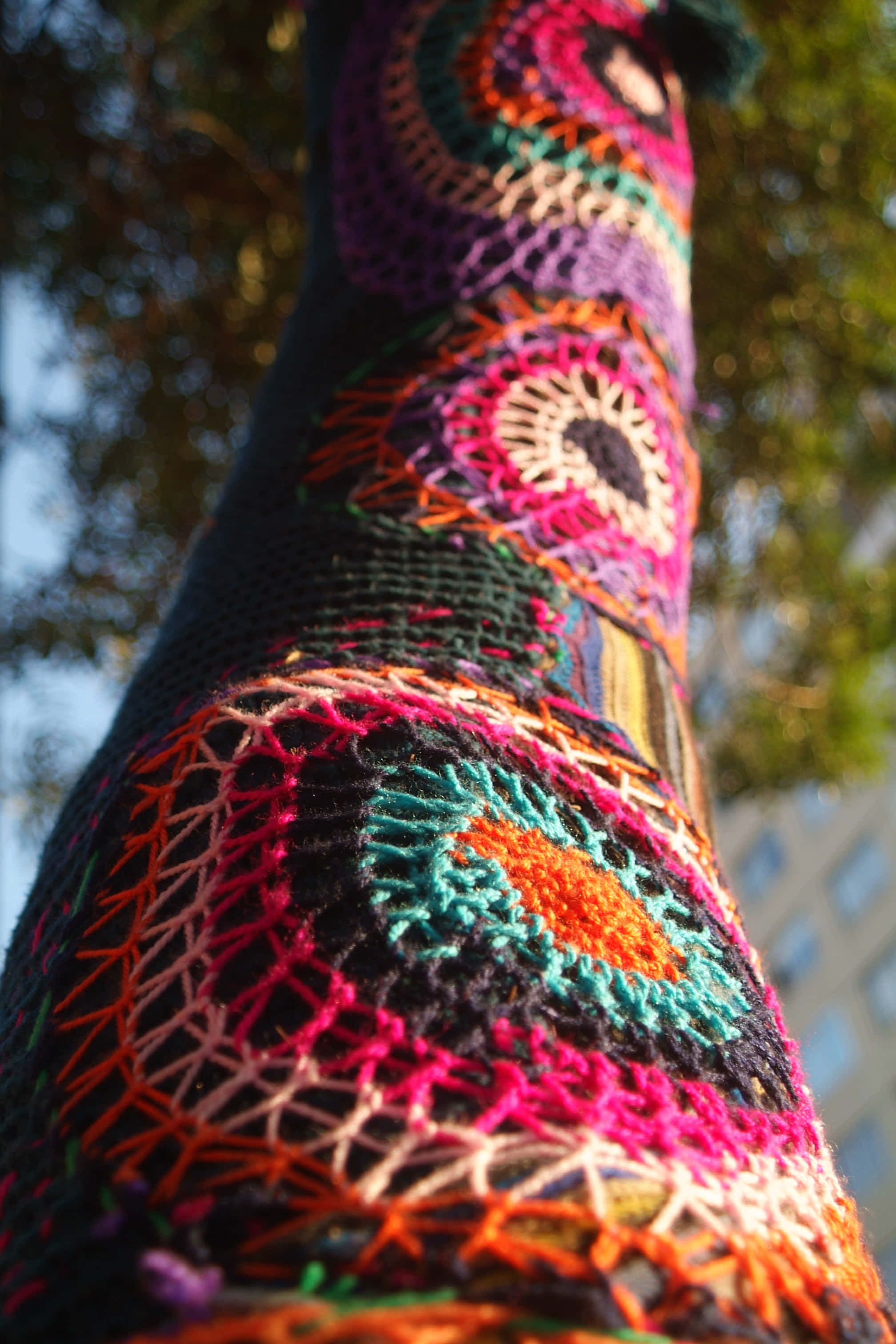 colorful crocheted tree trunk, knitting yarns, vibrant colorful crocheted patterns, 2K Phone Wallpaper