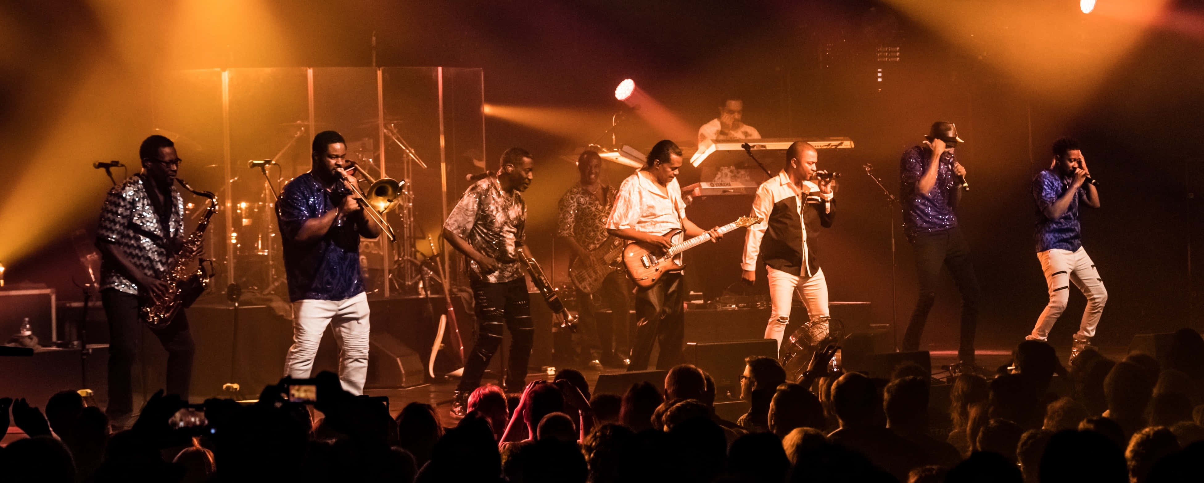 Kool And The Gang, live concert performance, warmly lit stage, 4K Desktop Wallpaper