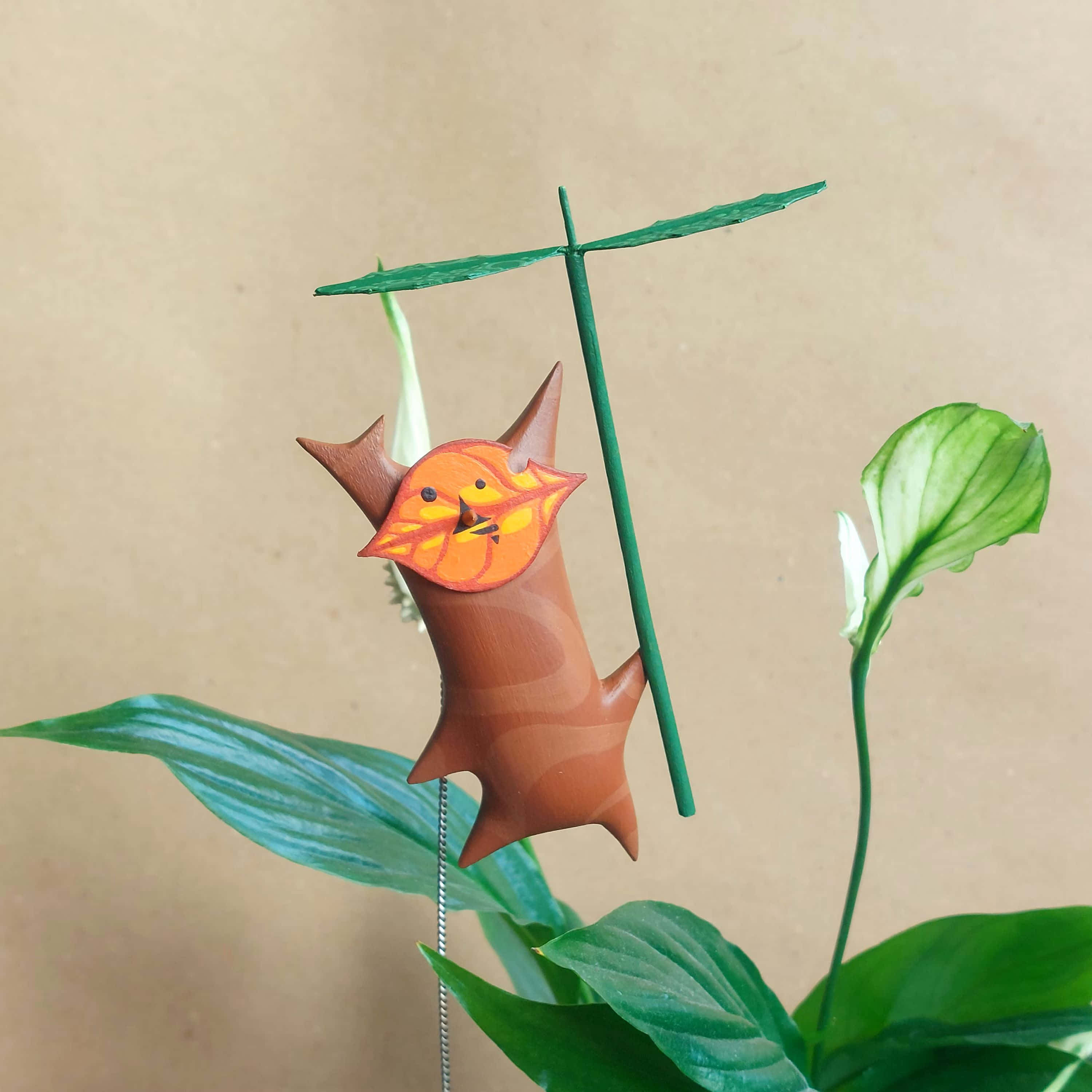 Korok, whimsical wooden bird figurine, orange leaf head, 2K Desktop Wallpaper