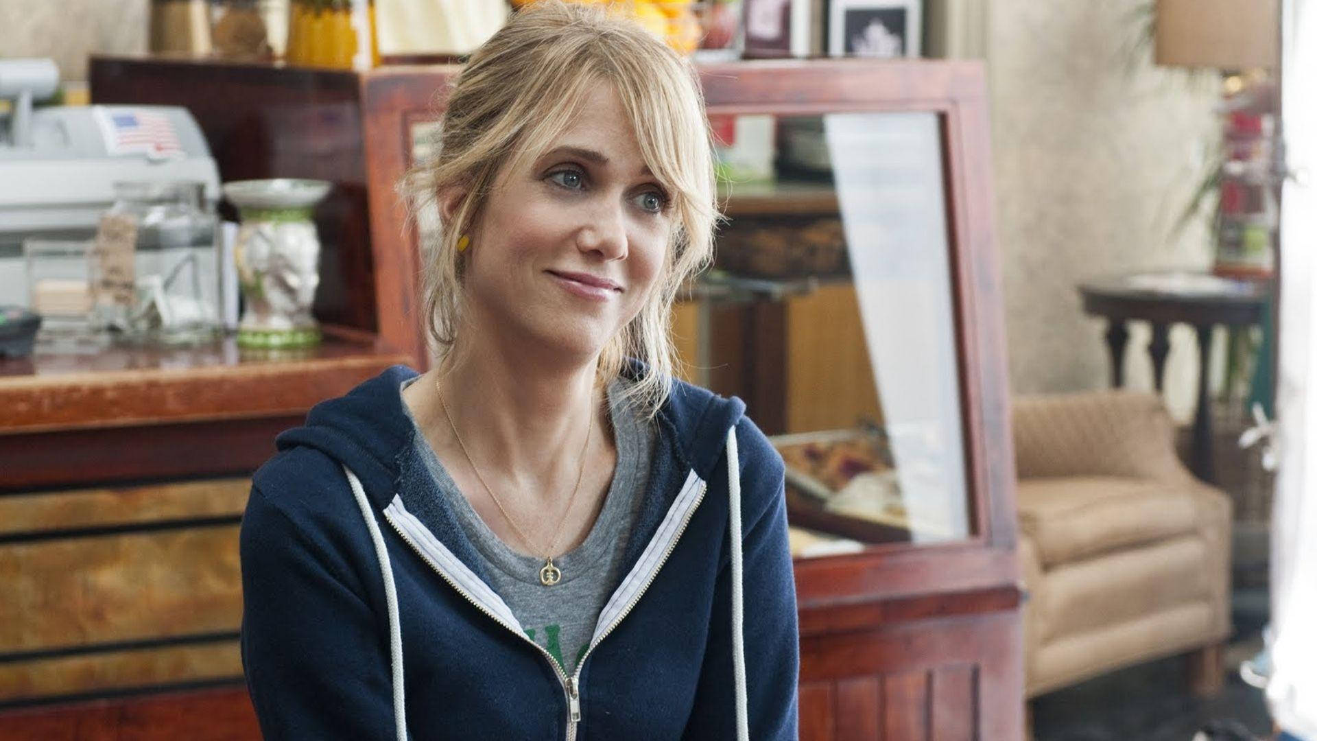 Kristen Wiig, navy hoodie, warmly lit cafe, Full HD Desktop Wallpaper