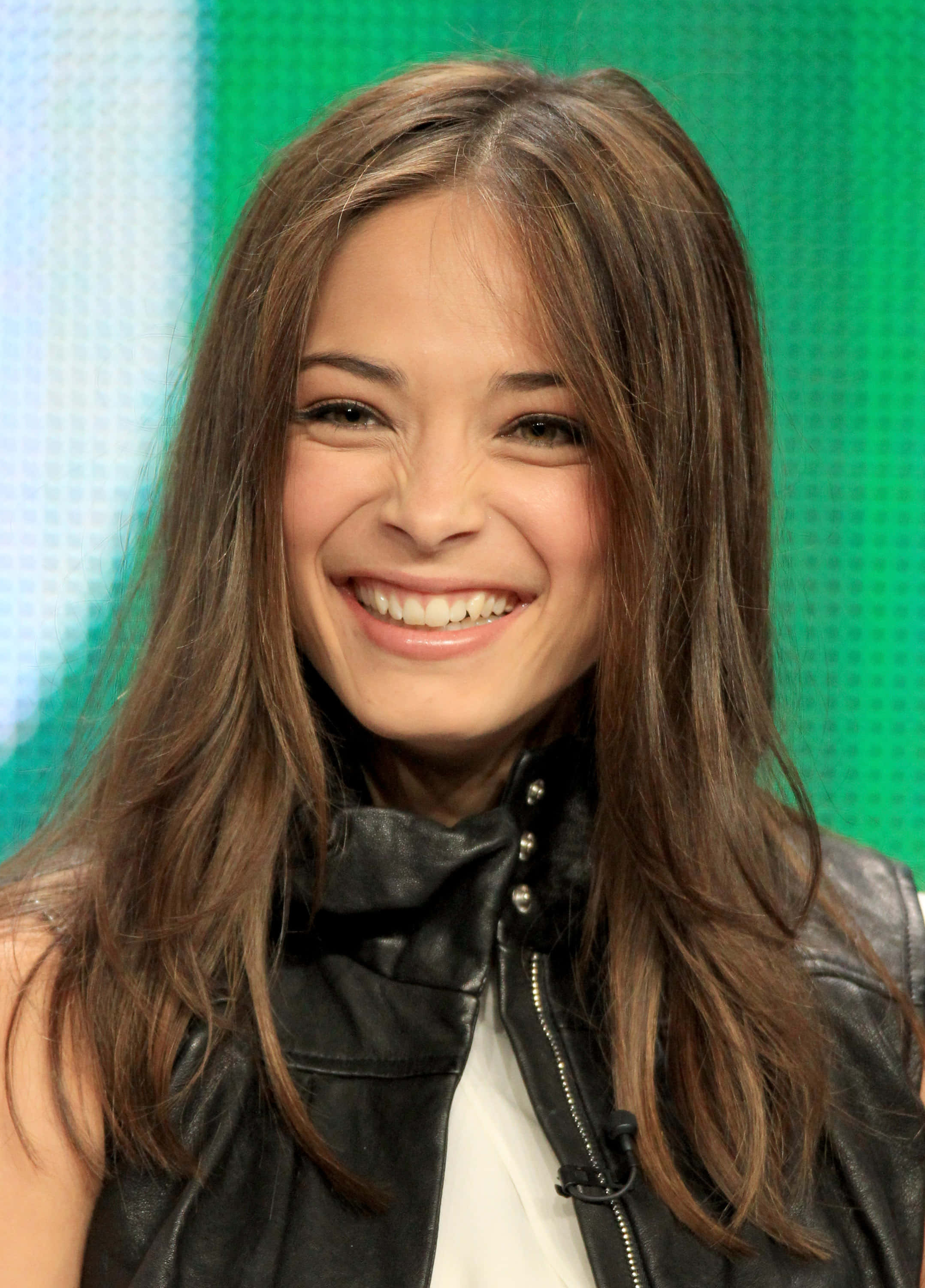 Kristin Kreuk, black leather vest, long brown hair, 2K Phone Wallpaper