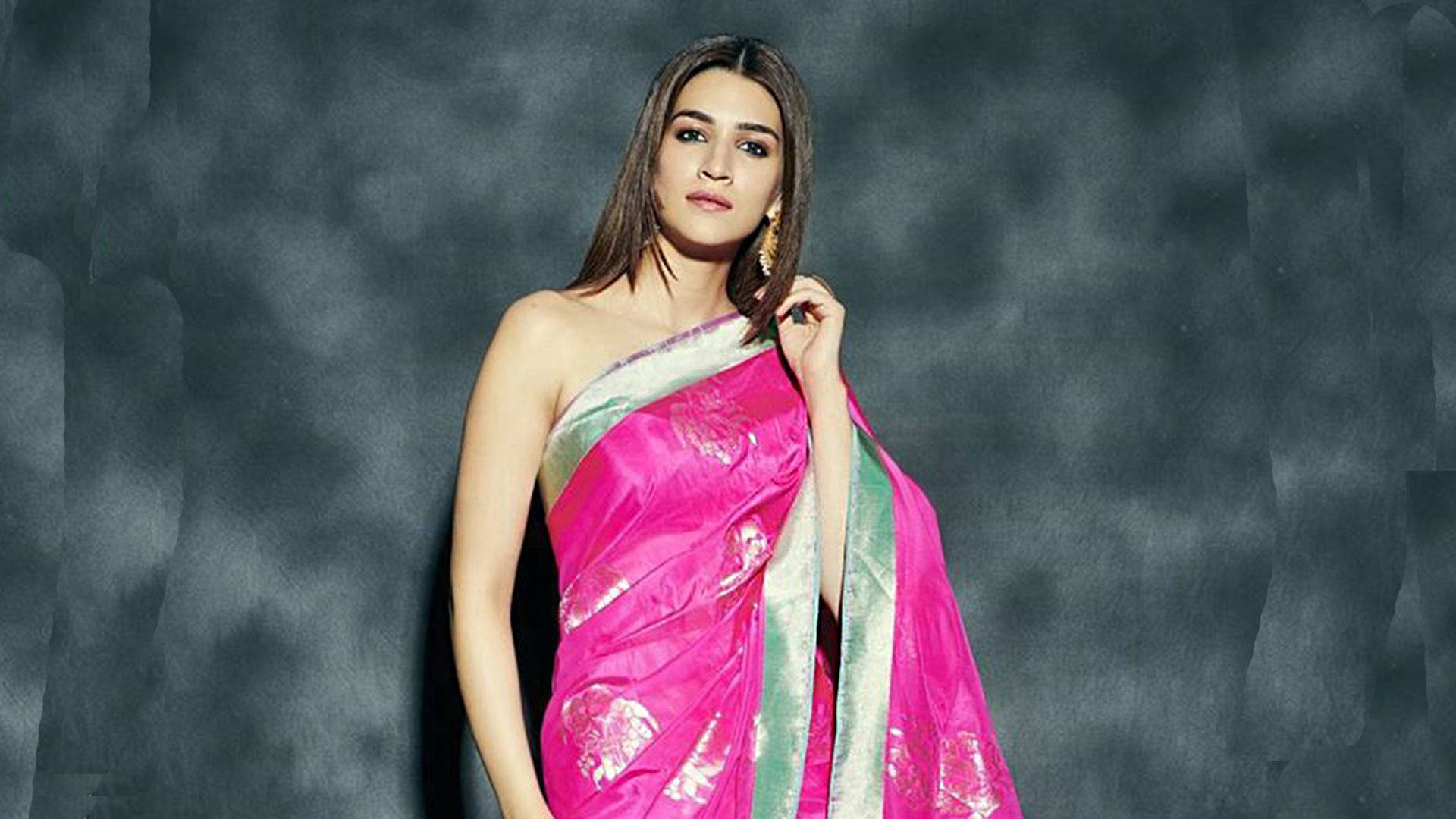 Kriti Sanon, vibrant pink and green saree, textured dark gray backdrop, Full HD Desktop Wallpaper