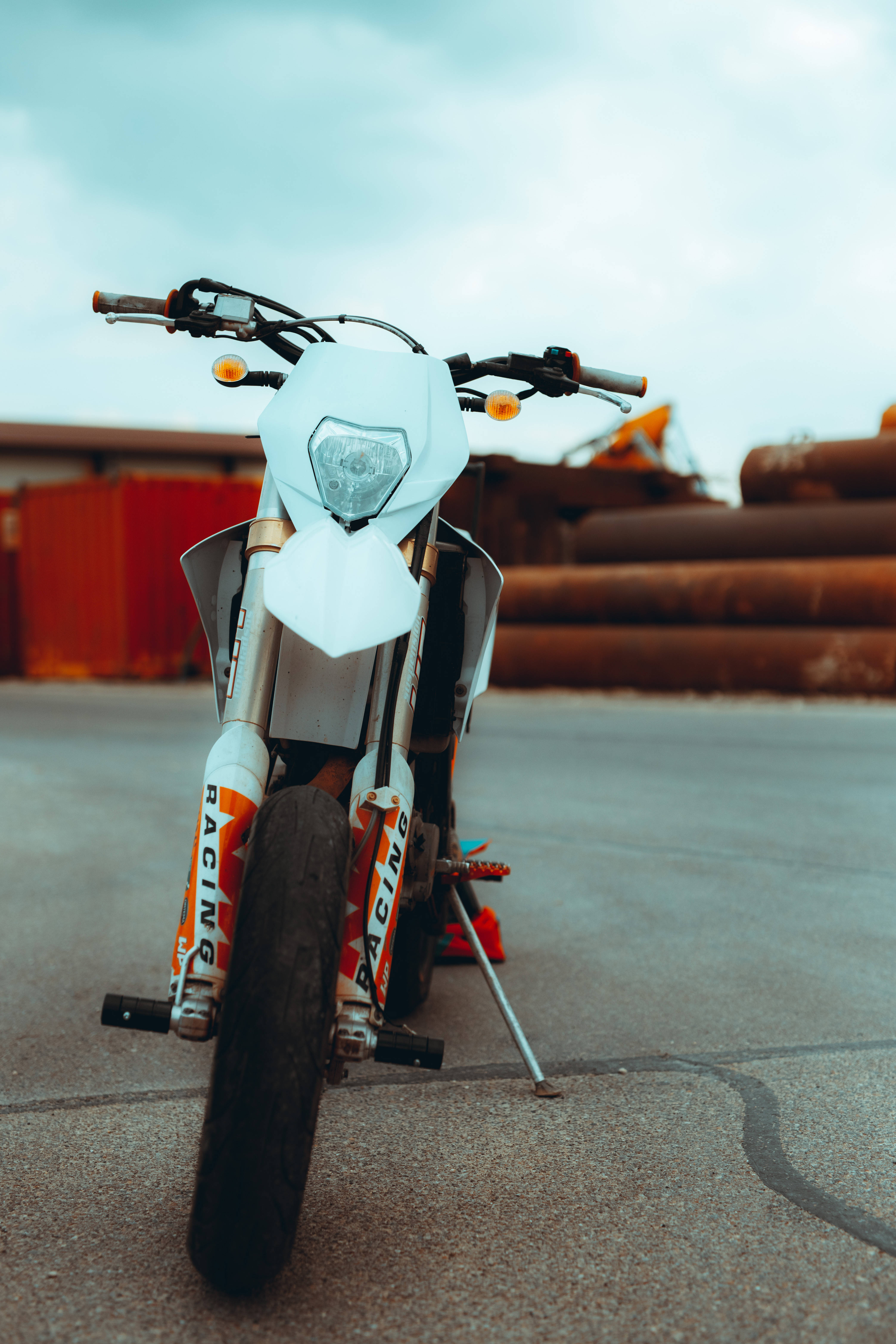 white ktm bike, orange racing decals, concrete lot, 5K Phone Wallpaper