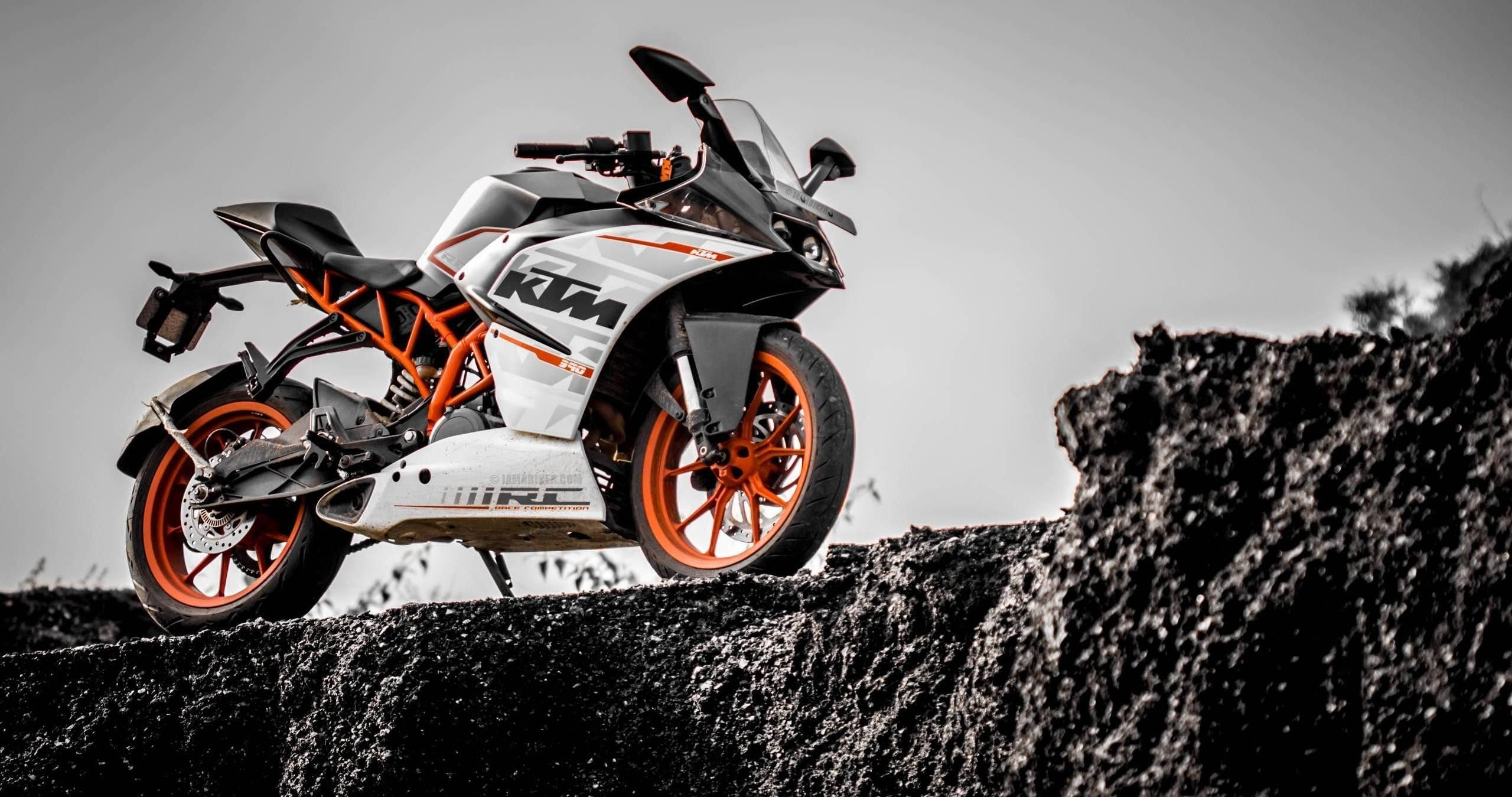 KTM Duke 390, white and orange, rugged black rock formation, 2K Desktop Wallpaper