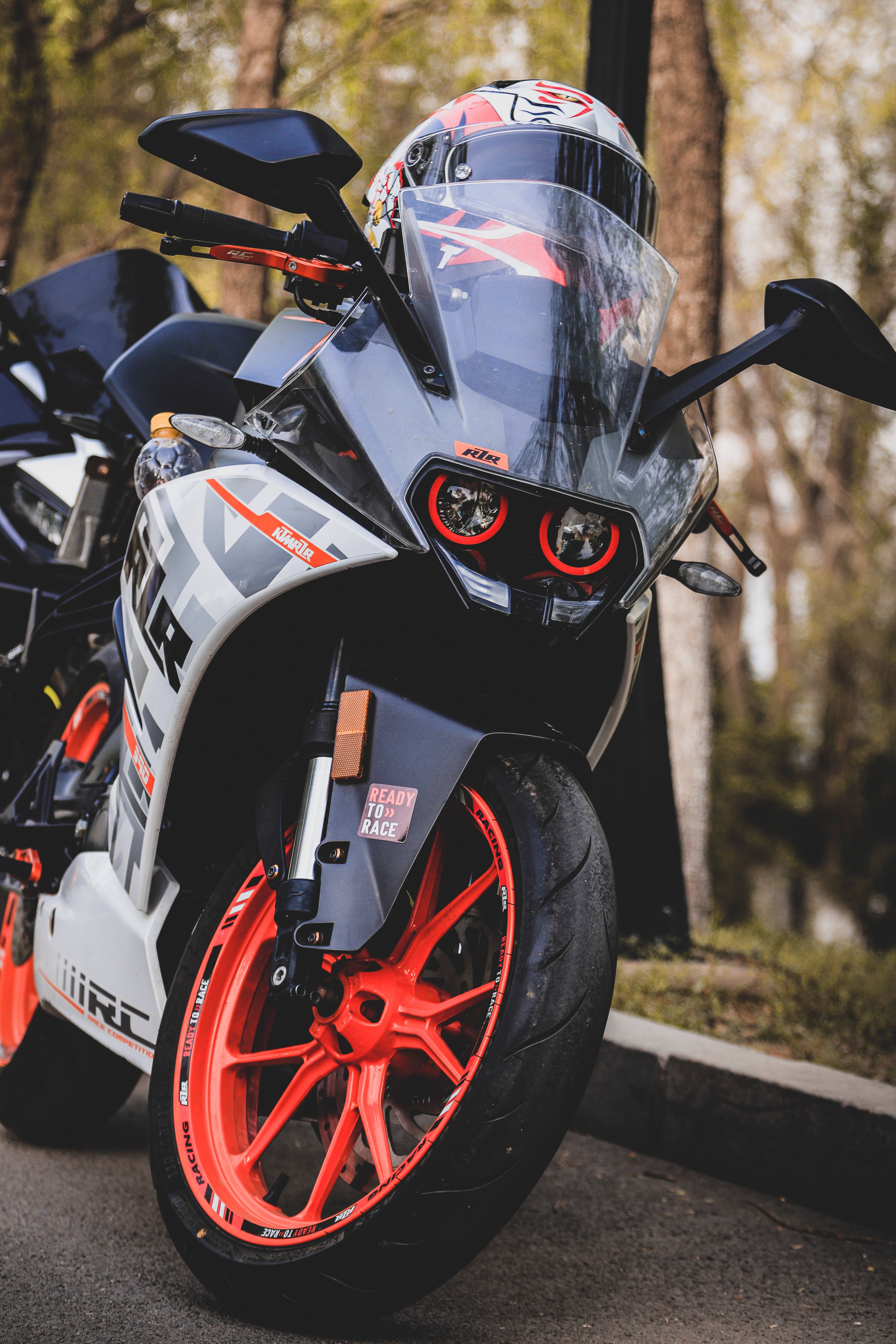 KTM RC 390, vibrant red wheels, rider's helmet, 5K Phone Wallpaper