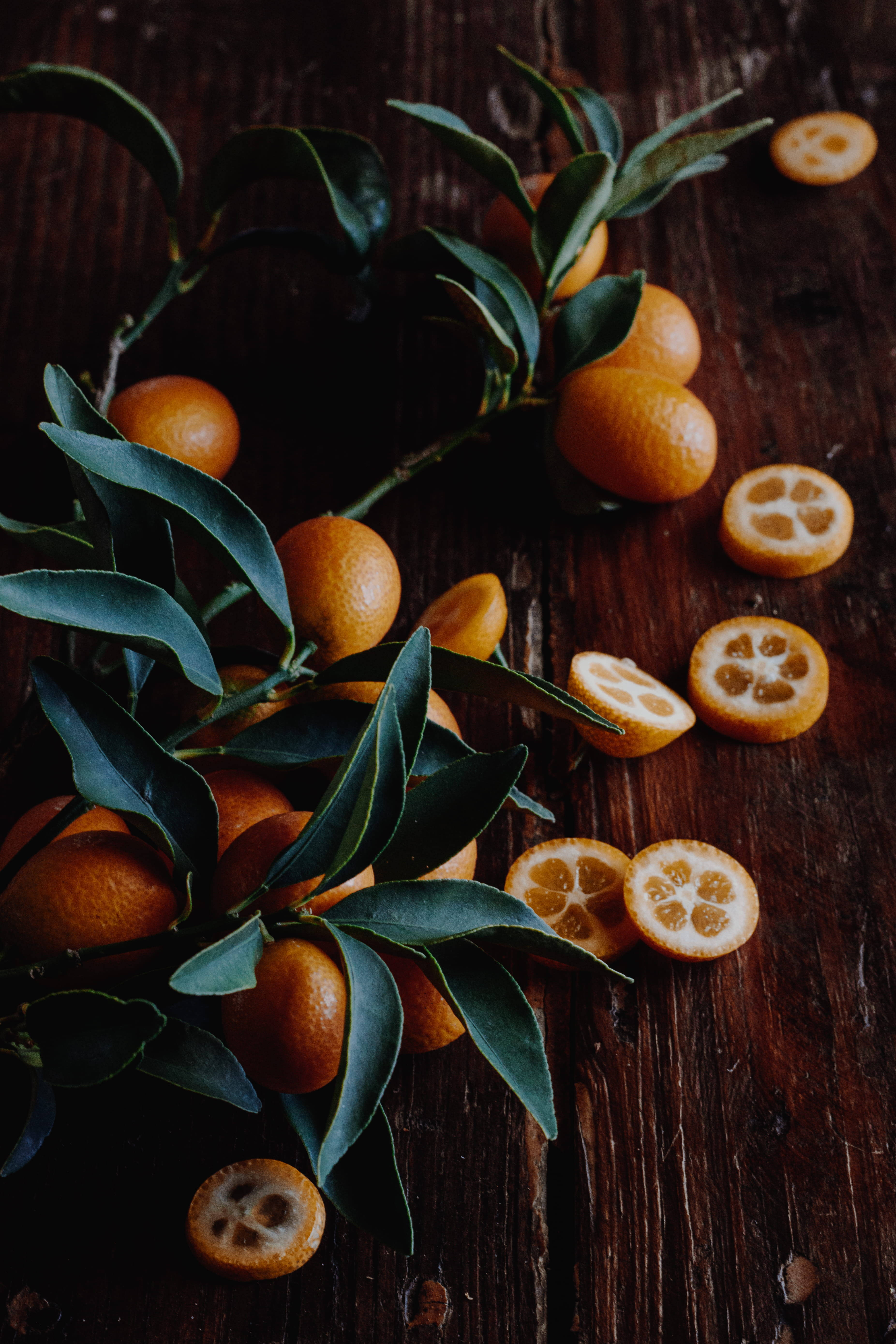 kumquat, glossy green leaves, segmented pulp, 5K Phone Wallpaper