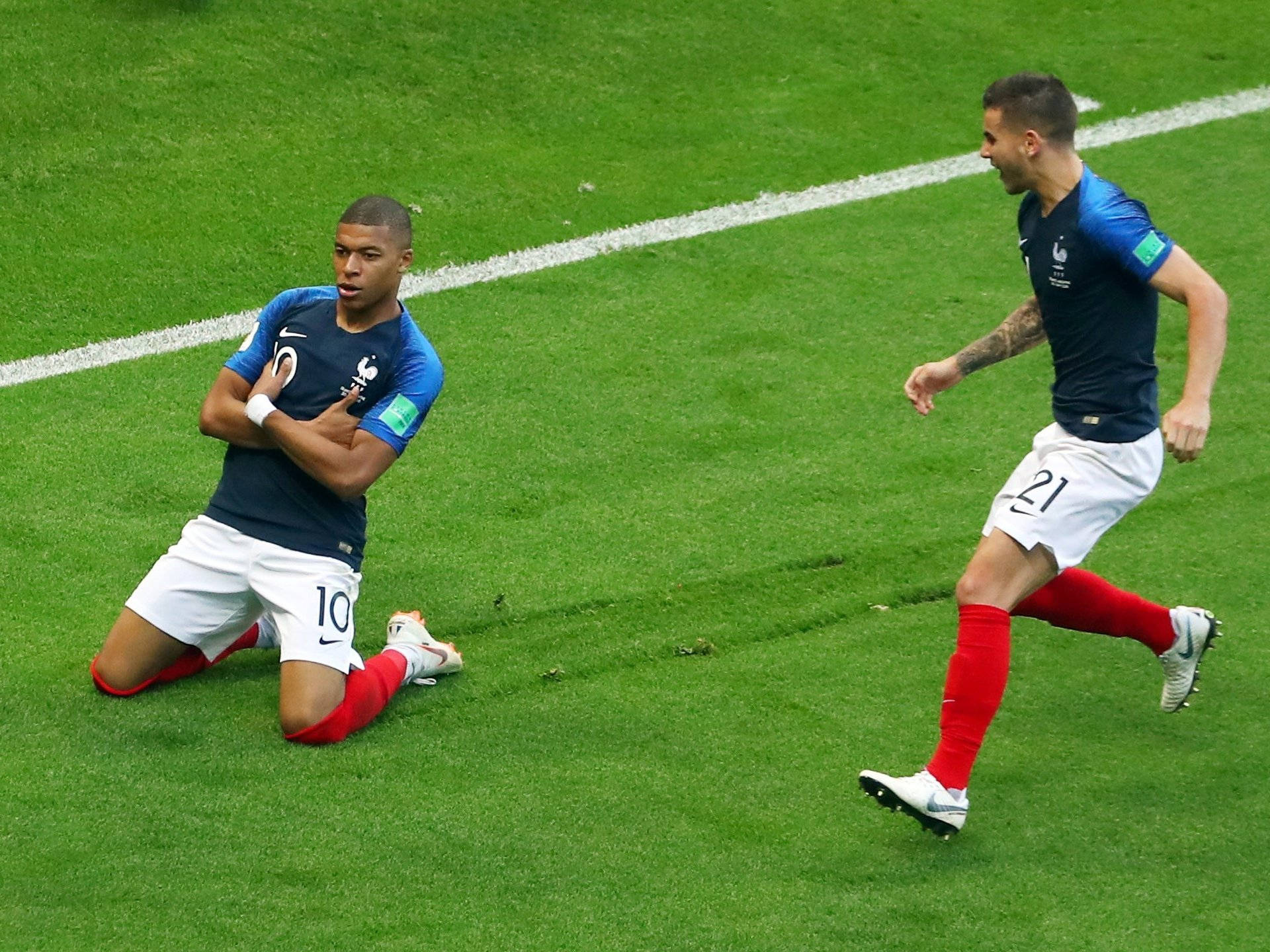 Kylian Mbappe, smug kneeling pose, vibrant green pitch, Full HD Desktop Wallpaper