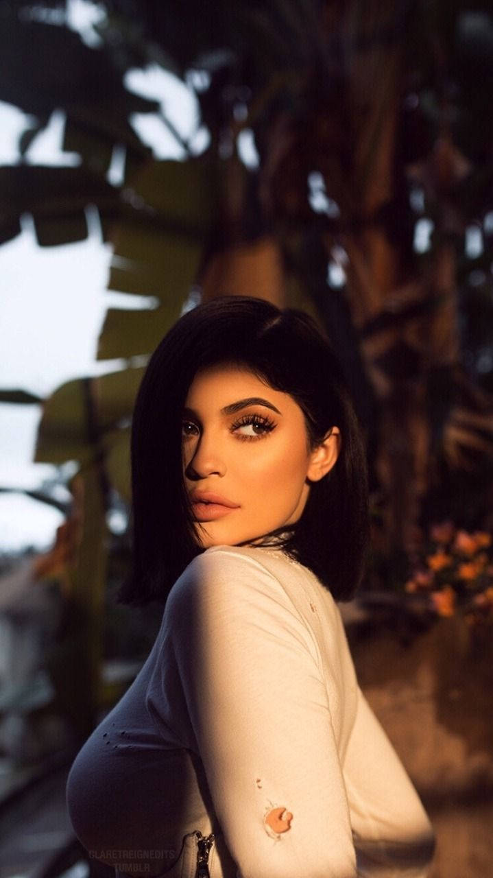 Kylie Jenner, tropical foliage, golden light, HD Phone Wallpaper