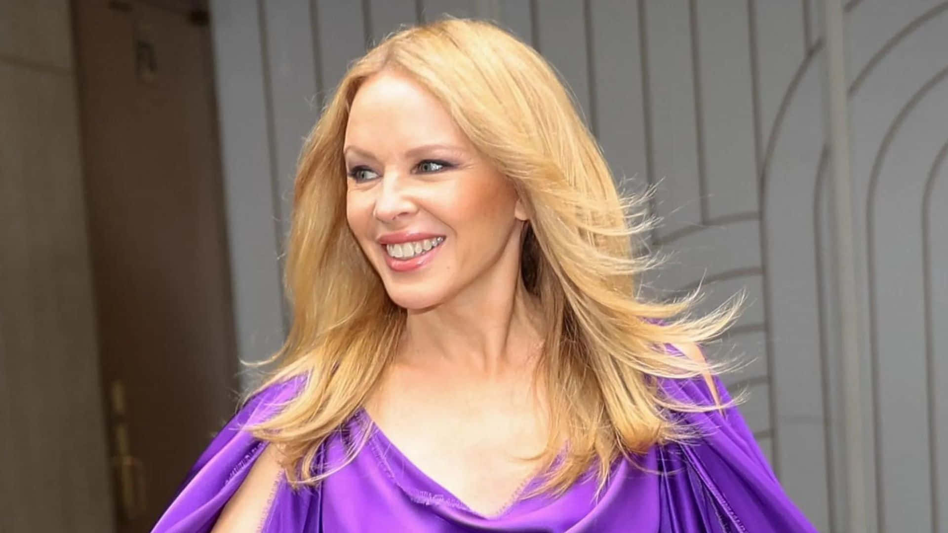 Kylie Minogue, vibrant purple satin dress, wind-swept hair, Full HD Desktop Wallpaper