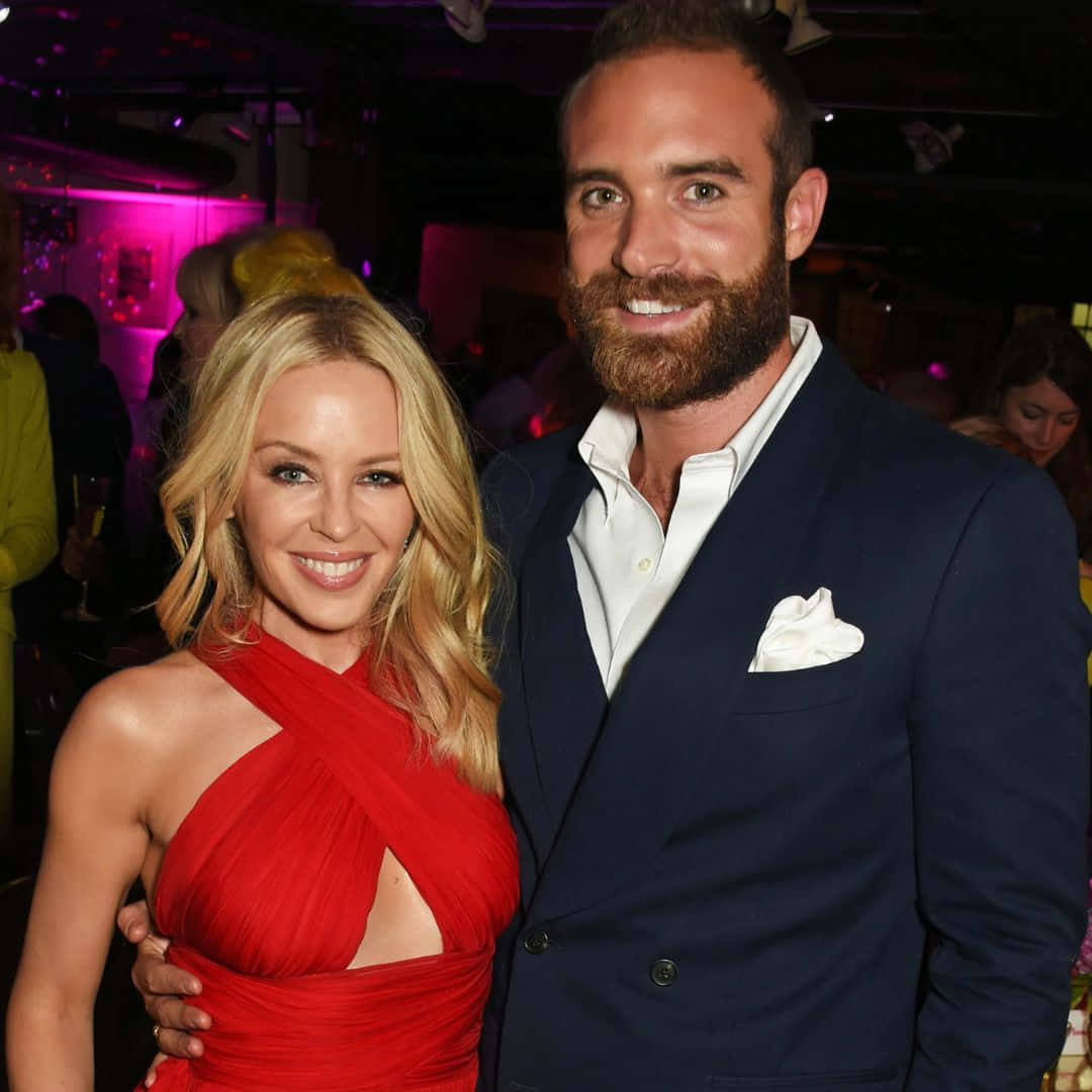 Kylie Minogue, red dress, navy suit, SD Desktop Wallpaper