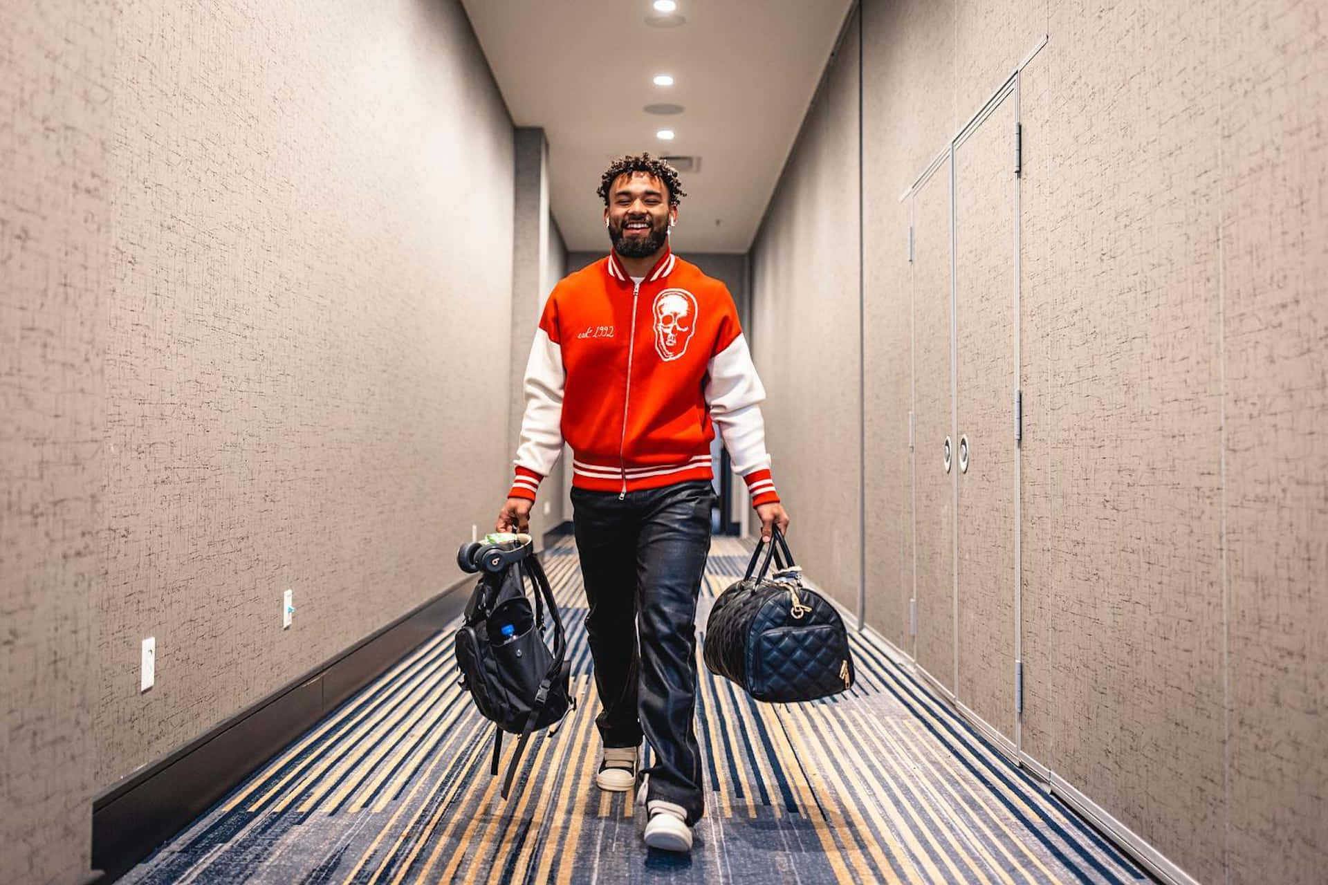 Kyren Williams, red and white varsity jacket, hotel hallway, Full HD Desktop Wallpaper